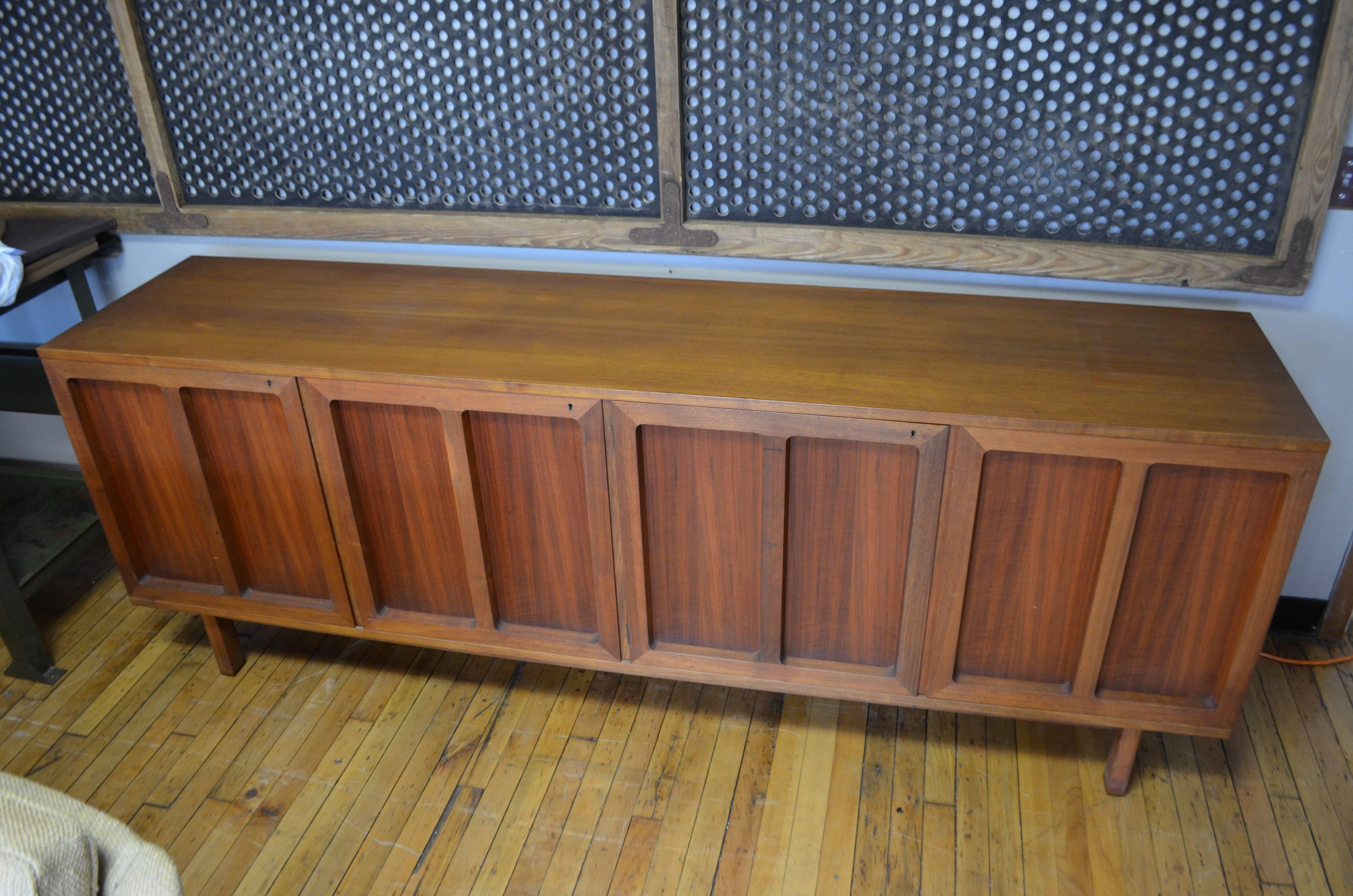 Mid-Century credenza / buffet of solid teak by Karl-Erik Ekselius for J.O. Carlsson, Sweden. Three doors, with recessed panels, open on left-hand compartment of six slide-out drawers and on spacious right-hand compartment with adjustable shelving