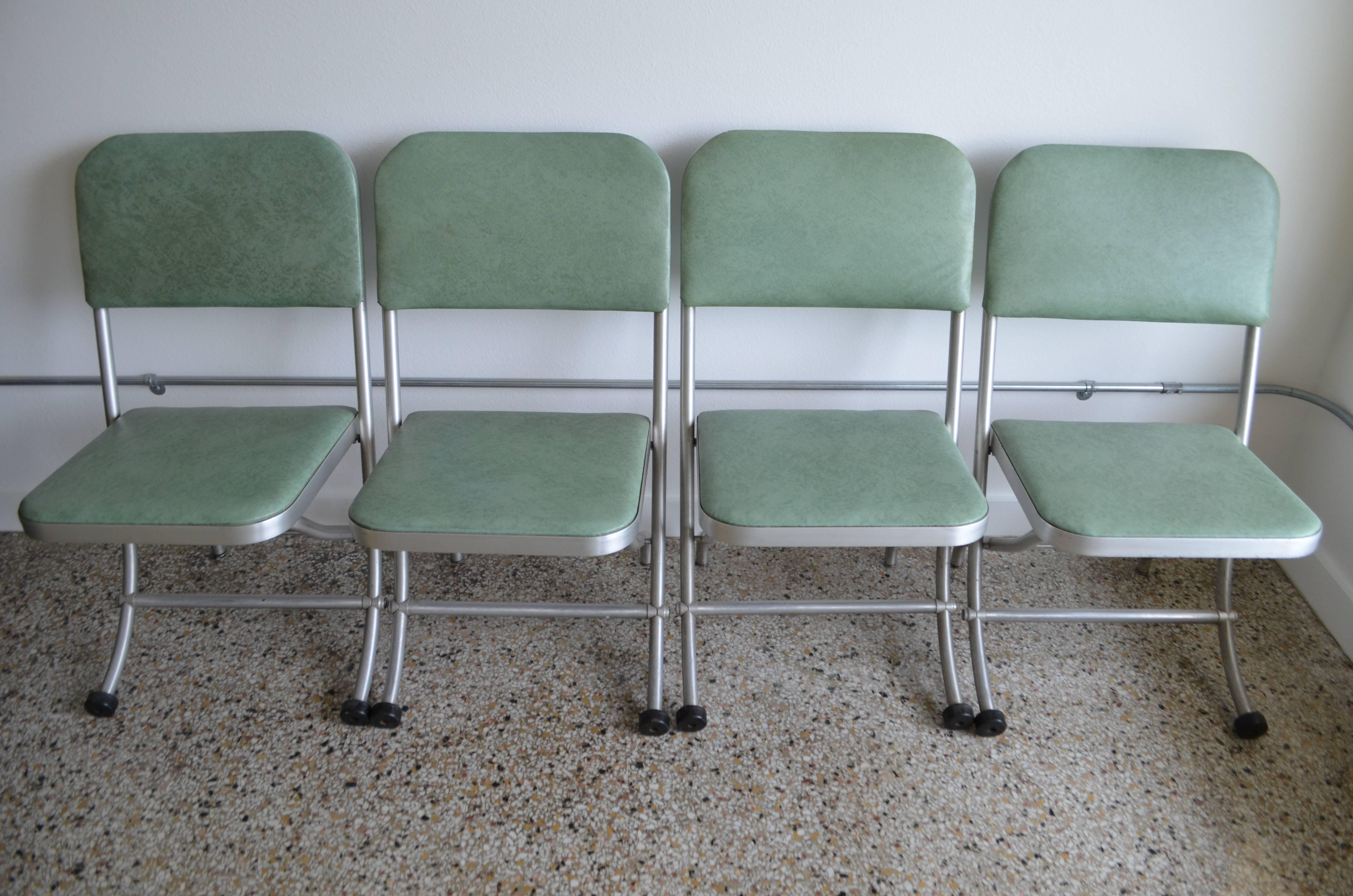 Mid-Century folding chairs (set of 3) of aluminum designed by Warren Macarthur with original mint green vinyl upholstery. Marked with labels underneath seat. Featherweight with extreme comfort and Classic MacArthur curved front legs. Mint condition.