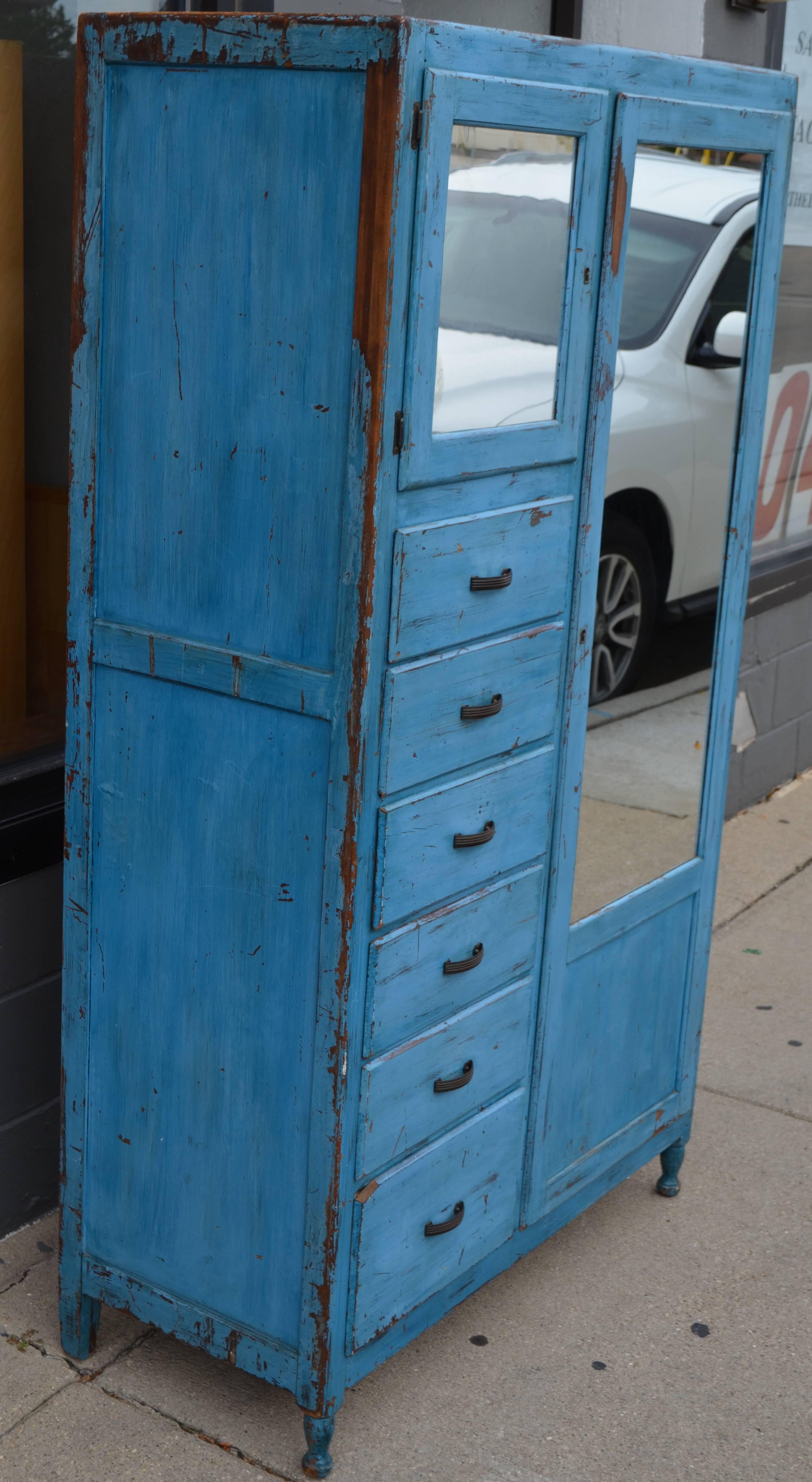 Storage cupboard with drawers, cubby and closet. As-found in lake cottage with wonderful blue patinated paint. Versatile storage capacity. The full-length closet is great for clothes, home and kitchen cleaners. With cup cubby and spacious drawers.