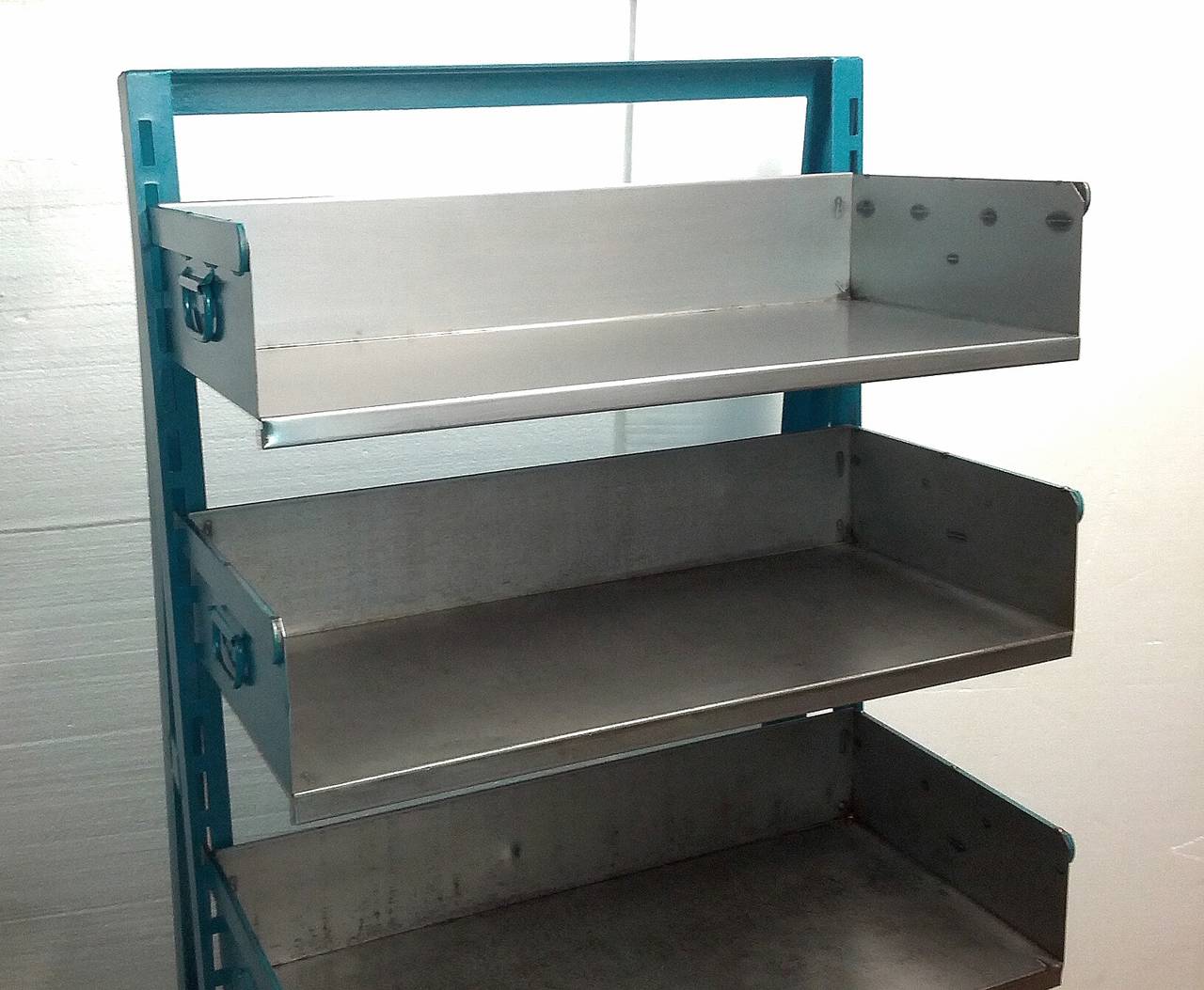 Straight from the factory floor- cleaned, sealed and room ready - this early A-frame shelving unit adds style and storage to any room. Can also be used as a bookcase. Easily adjustable bin shelves with handles. Casters allow it to move about easily.