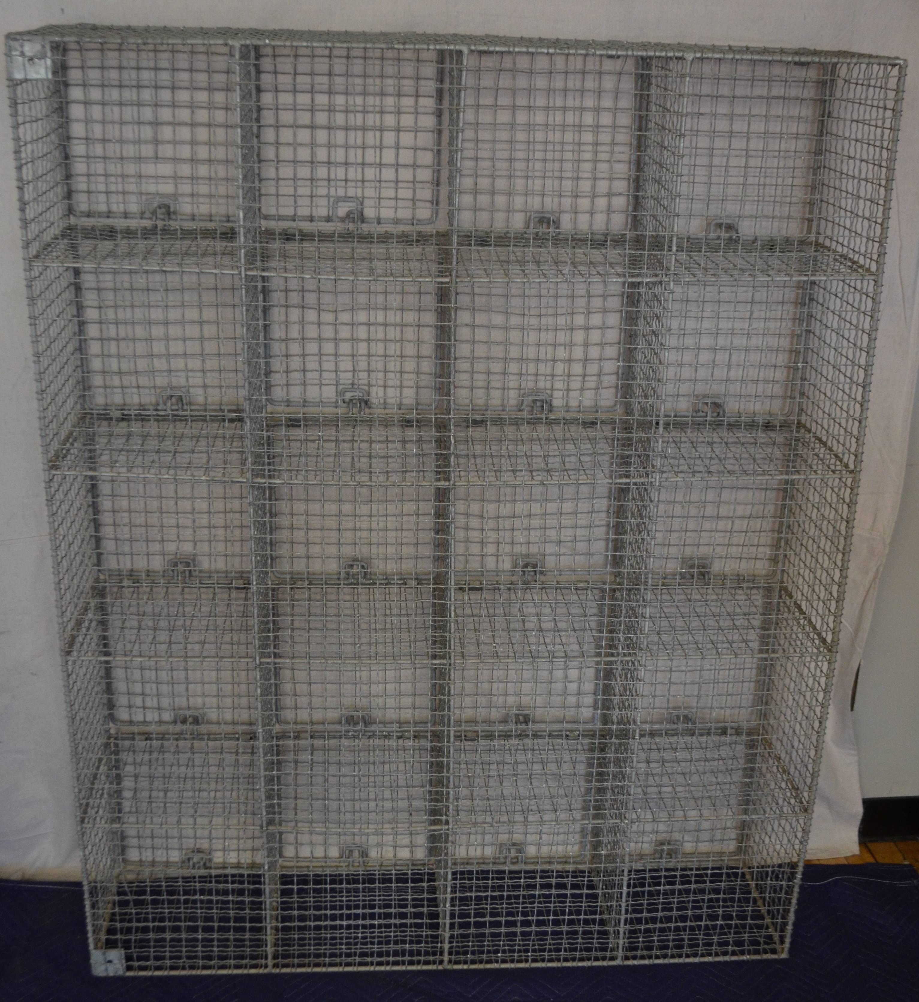 Storage cabinet with 20 steel wire cubbies, each with doors that swing up to open and close with loops that can be padlocked. Its use is myriad and versatile. In the entranceway for boots and gloves. In the bath for towels and accessories. In the
