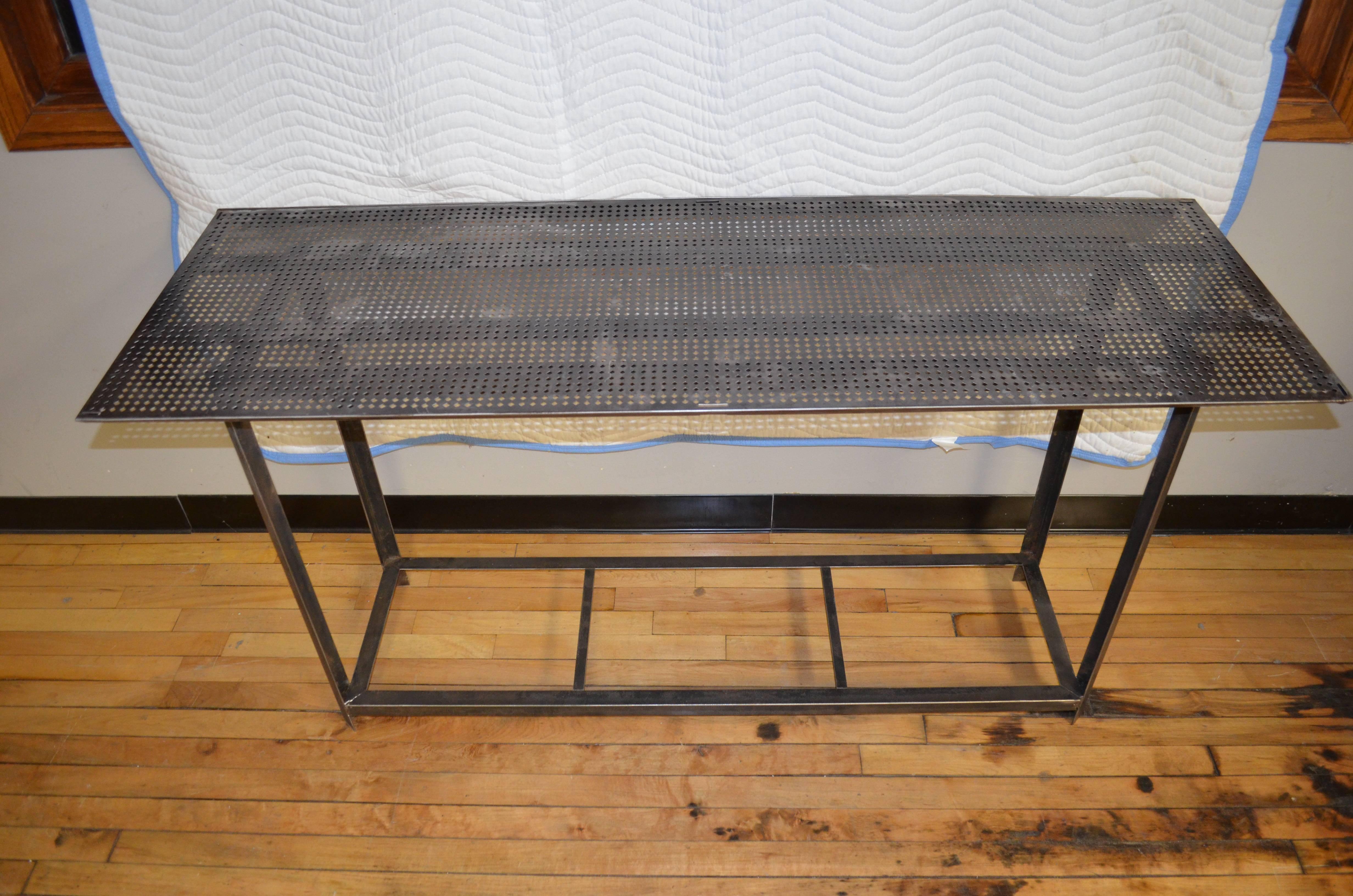 Factory work table with steel grate top stands sturdily on steel frame. Ideal as console table or plant stand. For an industrial table, this one has a wonderful light, airy quality.