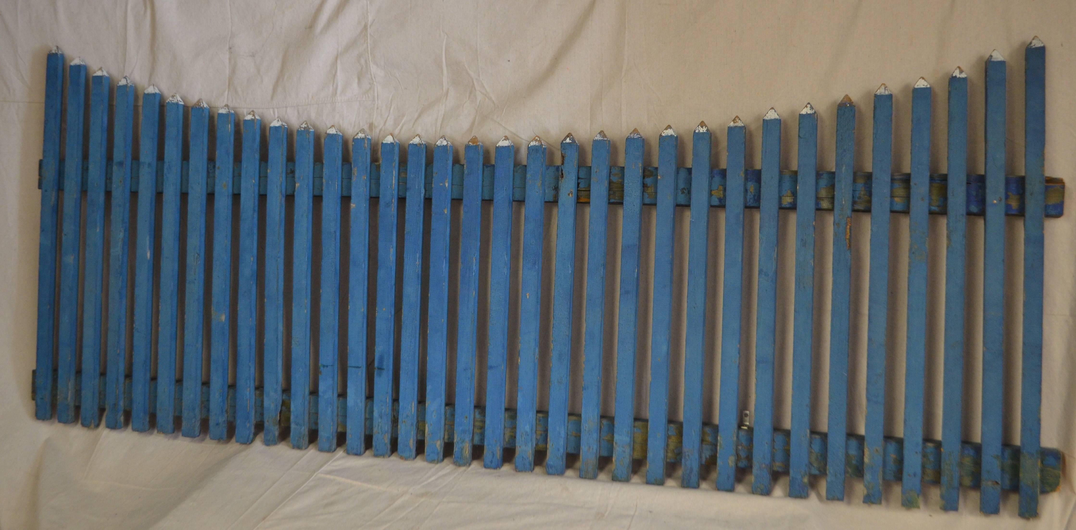 Garden picket fence in original as found blue paint with white tips.  Striking as sculptural wall hanging. 