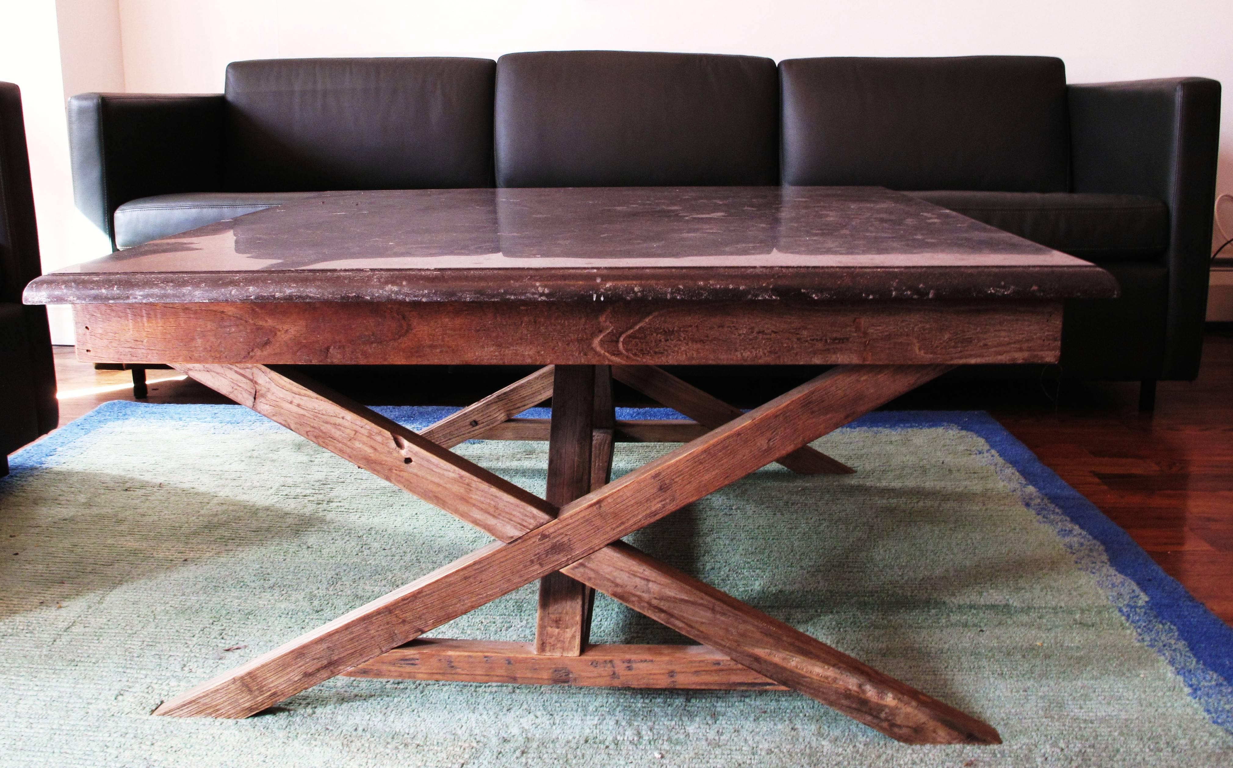 Bluestone slab on reclaimed wood coffee table with two discrete pullout wood shelves in excellent condition.

 