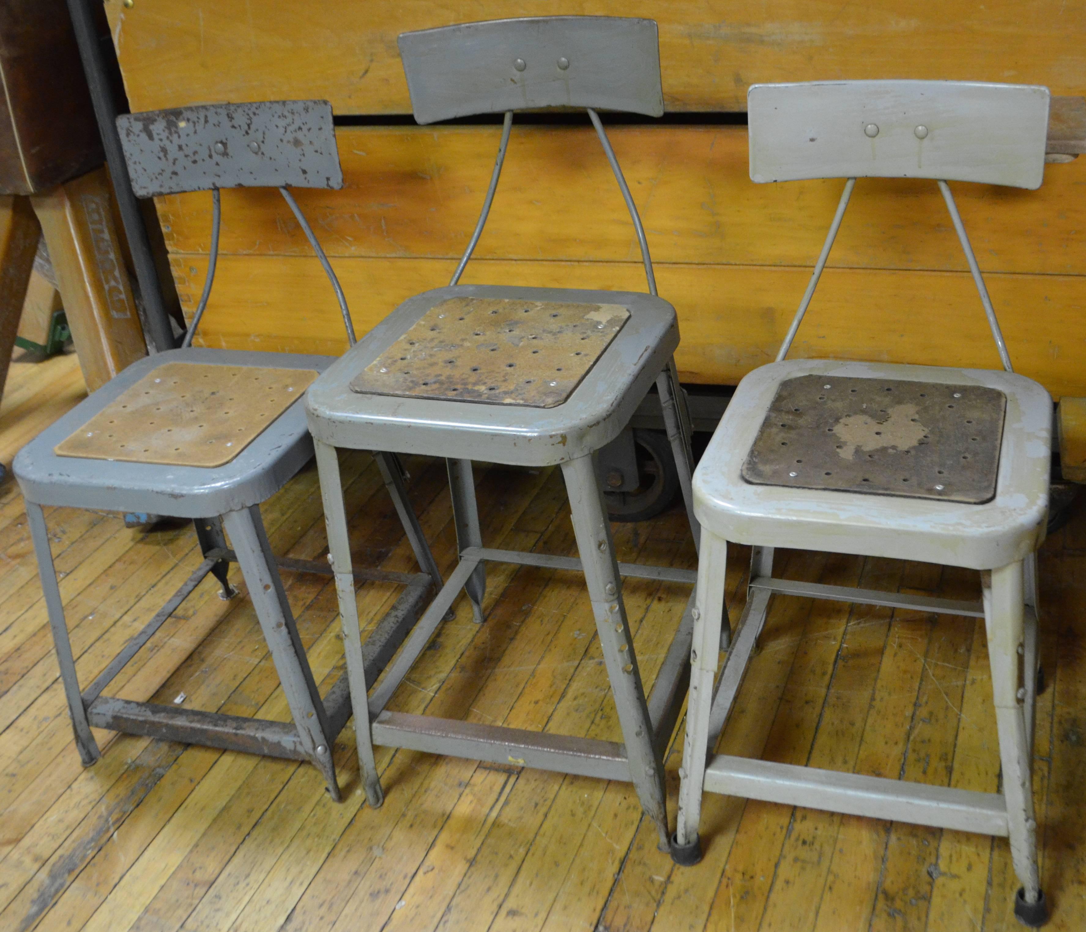 Factory steel chairs, set of three. Actually there are four Industrial chairs total but one didn't make the photo. We will include that 4th stool without charge. In other words, free when you purchase the set of three. Their height can be adjusted