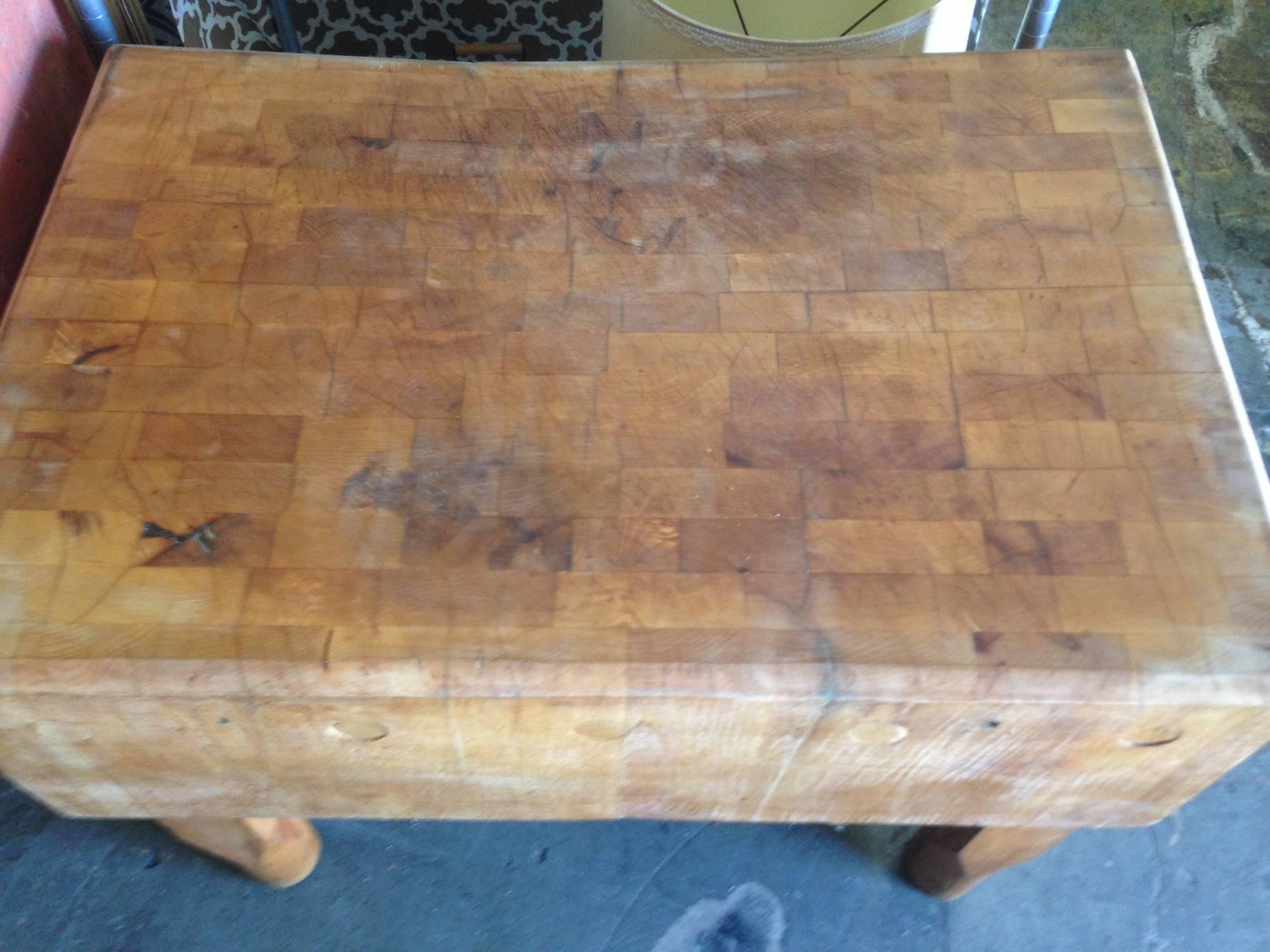 Butcher block from New York meat market dates back to the early 1900s. Rock solid maple with wonderfully patinated top of use and wear and carved out legs. You could dance on the top. It's not going anywhere. Put on wheels and raise it to island