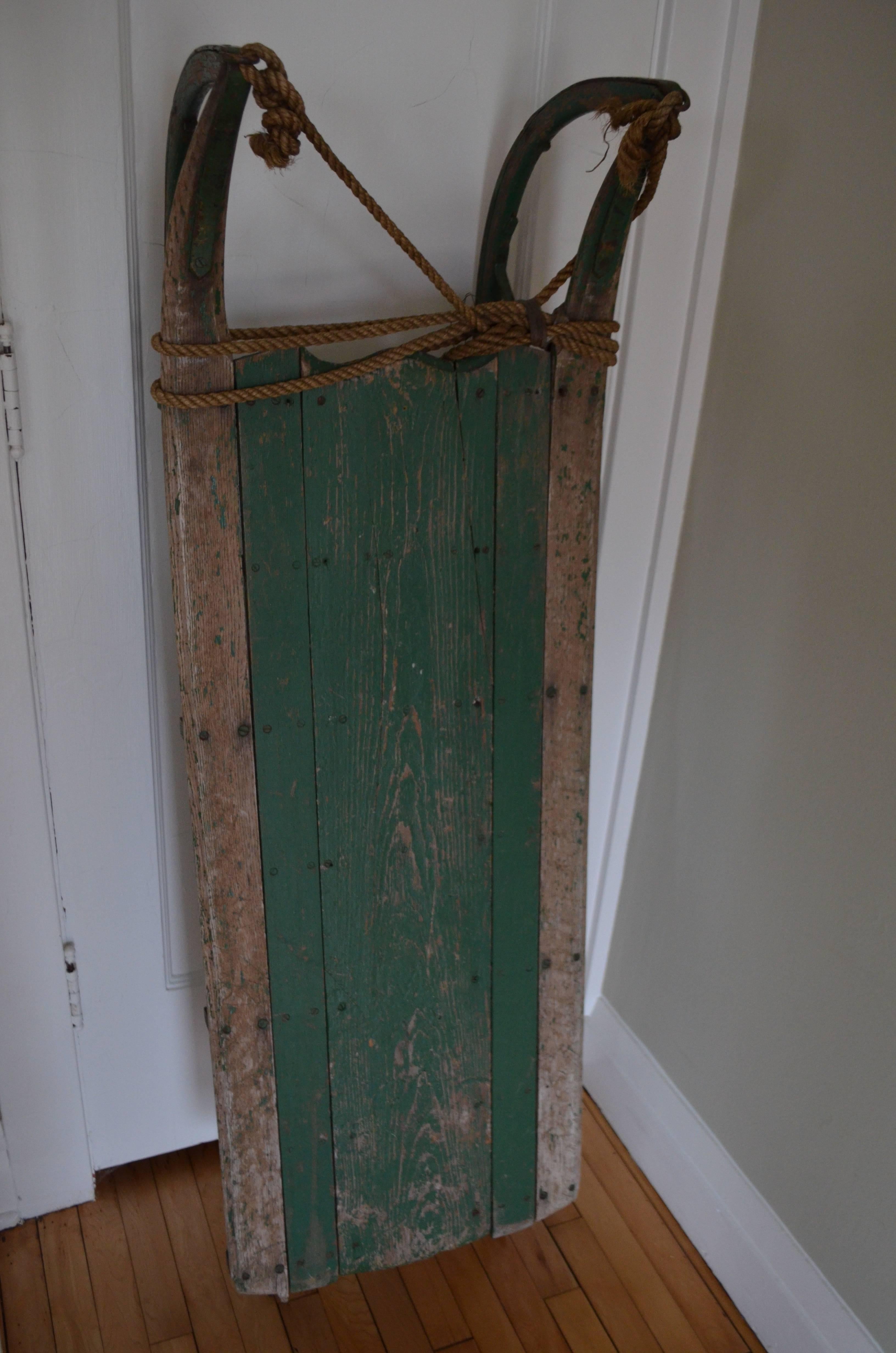 Sled from Maine handcrafted in the style of Folk Art. What that means to us is that when its snow sledding days are over, you've got a handmade artifact of beautifully worn wood, paint and metal for wall display in home, child's room, your ski lodge.