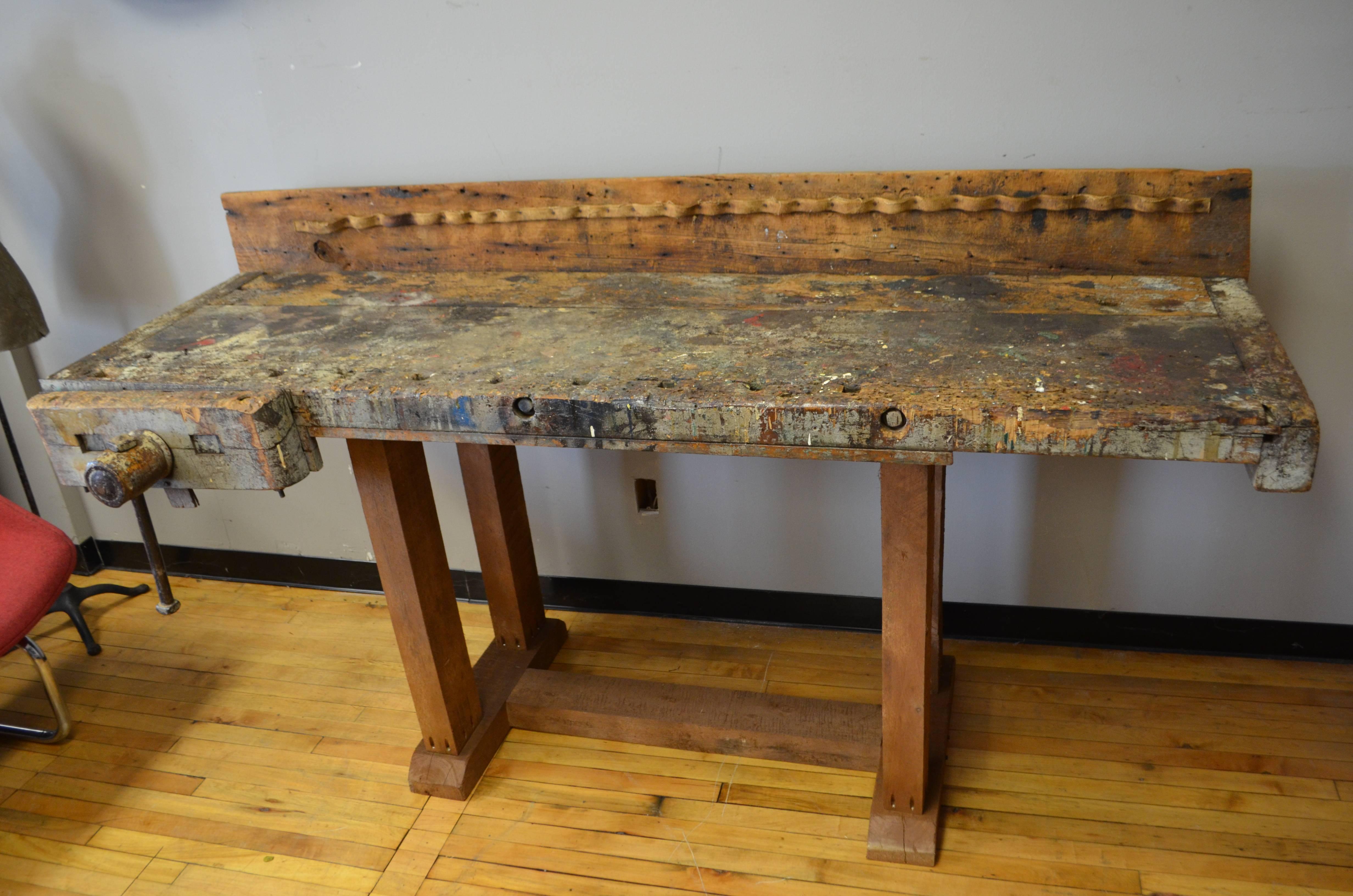 Primitive woodworker's butcher block table with wonderful patina of paint stains, work divots and gouges, late 1800s. Canvas tool holder on back board. Sits solidly upon a base fashioned from reclaimed cedar. Cleaned and sealed. Depth noted is