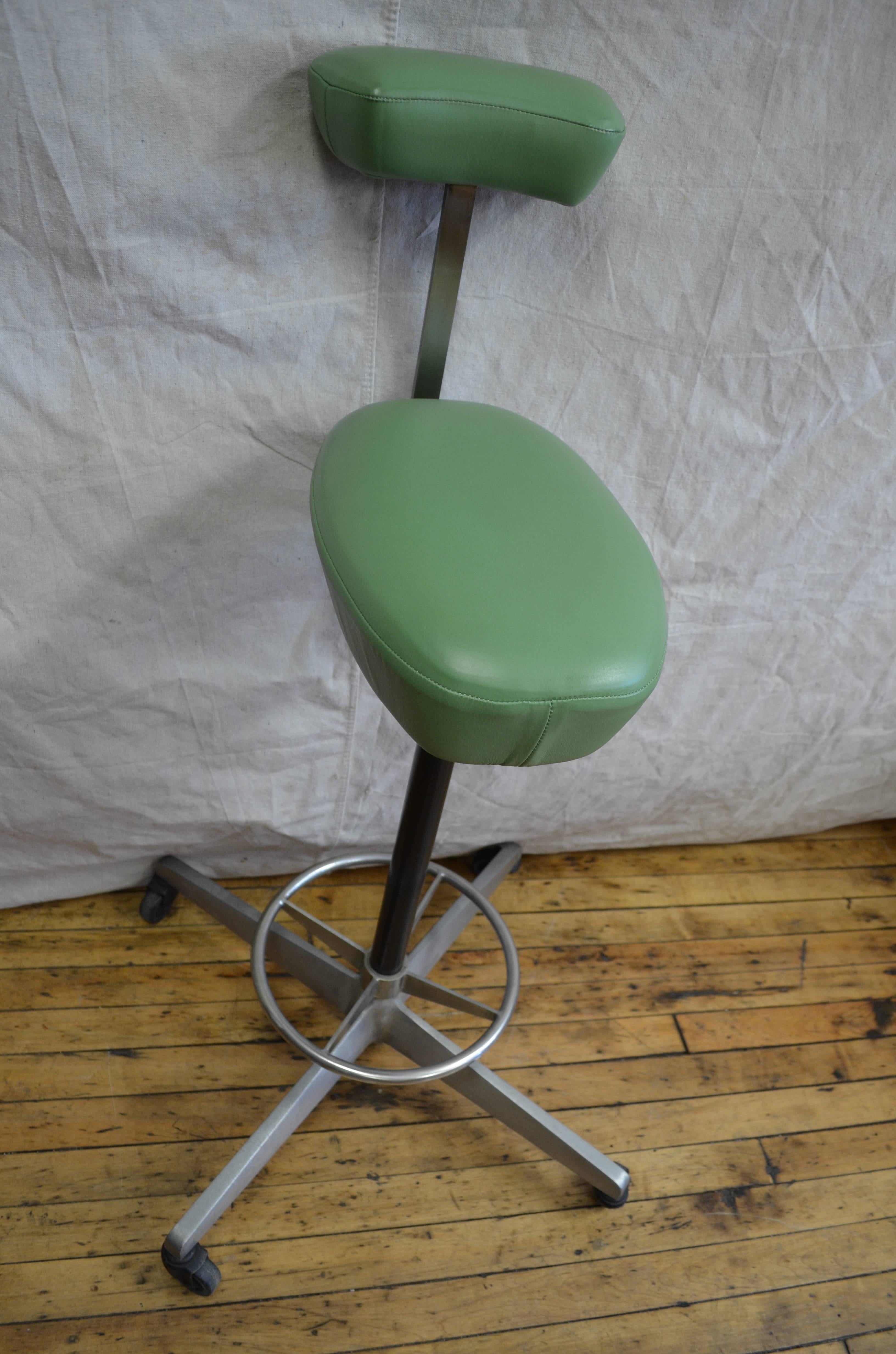Drafting stool called the Perch was designed by Robert Probst with George Nelson in the 1960s. Part of the action office series of furniture for Herman Miller. This particular Perch has been recovered in Spinneybeck green leather. It functions