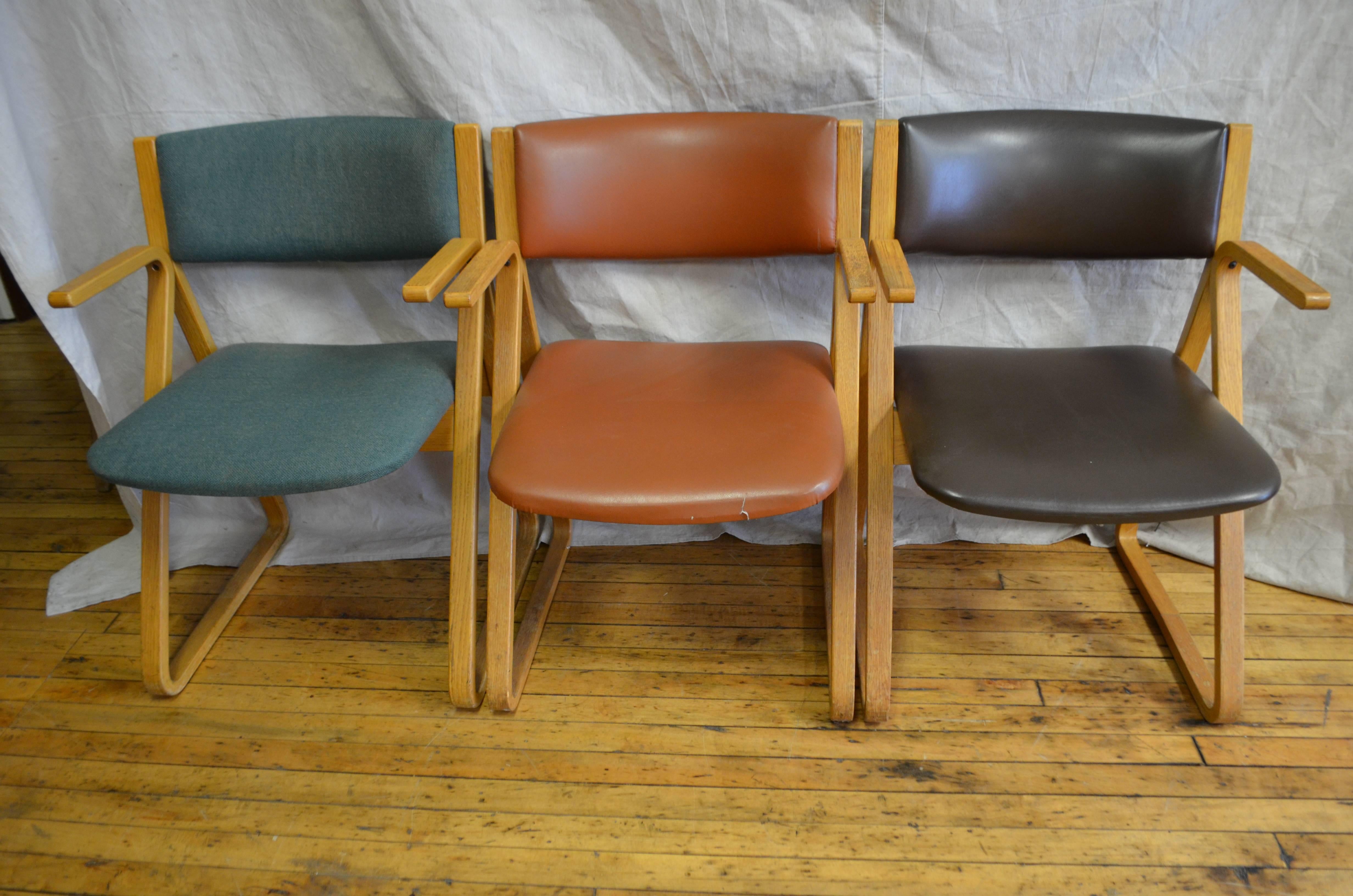 Dining room chairs from Stow/Davis of Michigan. Set of three, Mid-Century Modern. Their frames are maple. Two are upholstered in Naugahyde, one in nylon. Solid, comfortable and clean. Ideal as side chairs, for overflow holiday seating, for a smaller