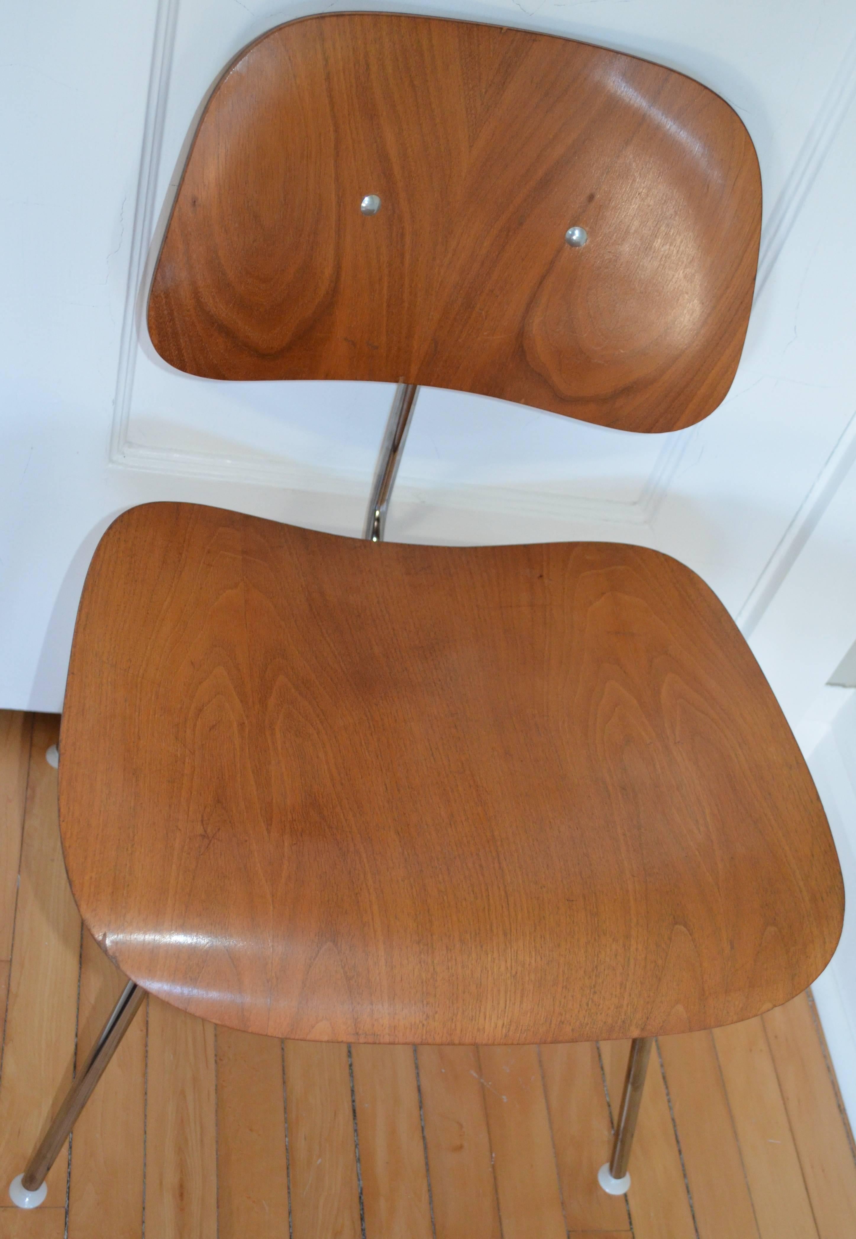 Mid-Century Modern Herman Miller Classic walnut dining room chairs (circa 1950s) with new stainless steel frame from Herman Miller. Price and shipping cost is for one chair. Quantity available. Seat height is 18 inches at front and 16 inches at