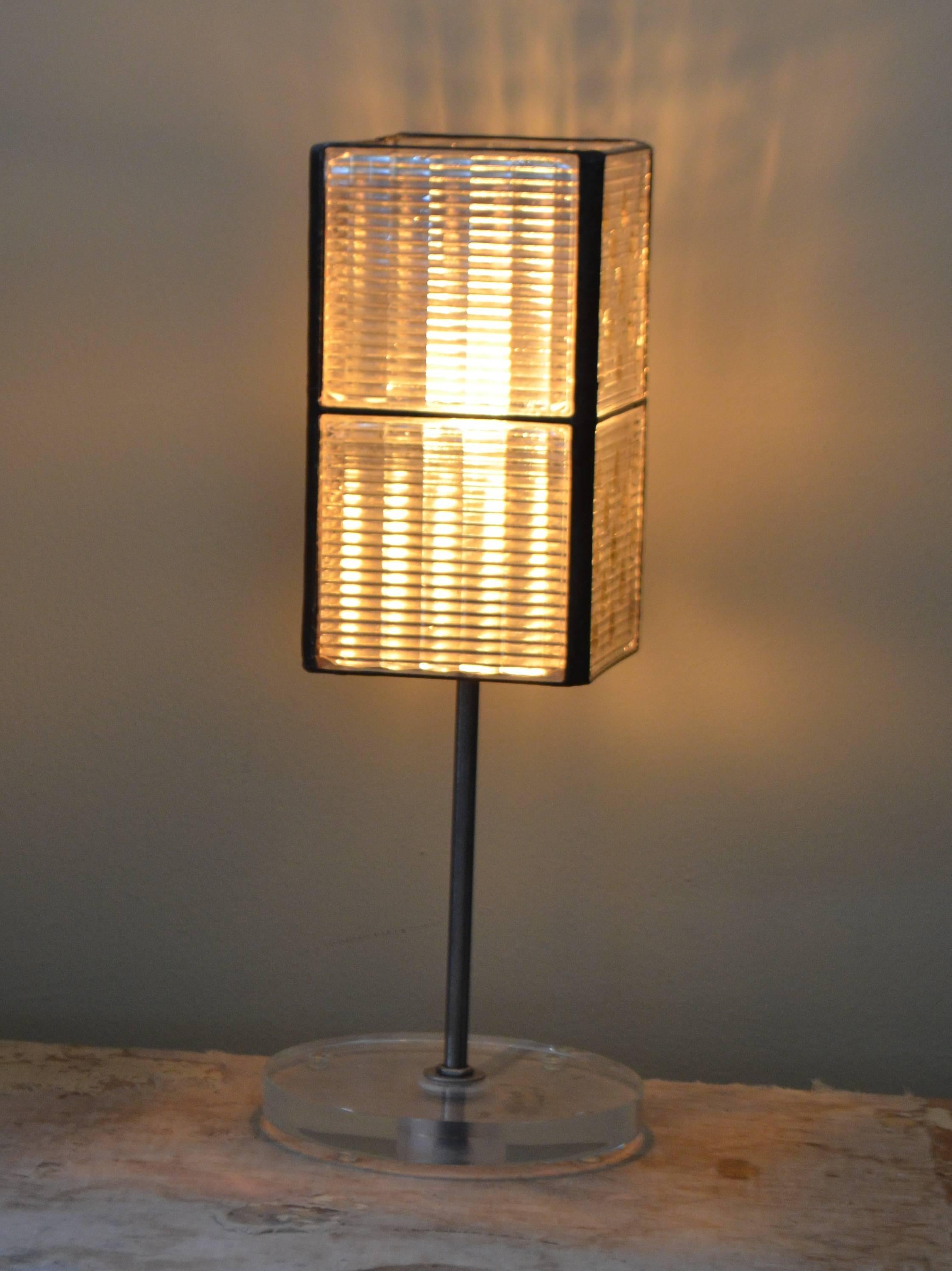 Table lamp has been created from eight glass Luxfer tiles of the teardrop design. At the turn of the 20th century, before electricity was widespread, glass Luxfer tiles were used in main street storefronts above door and windows as transoms that