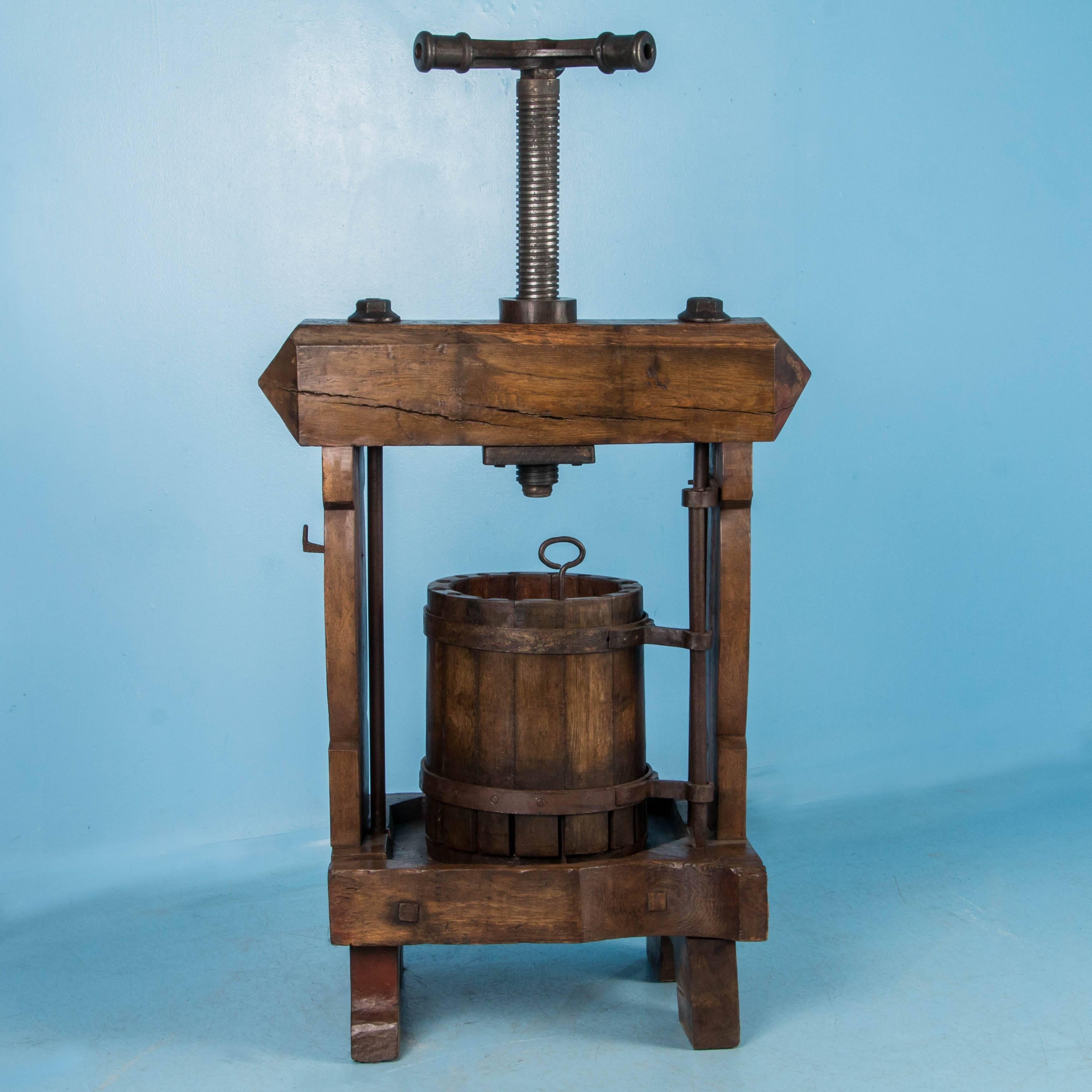 This wine press is a rare find, handcrafted from solid oak, circa 1900. The heavy gauge of the hand-thread iron shows dramatically against the oak, creating a very strong visual appeal. This will be an exceptional addition to any wine cellar, winery