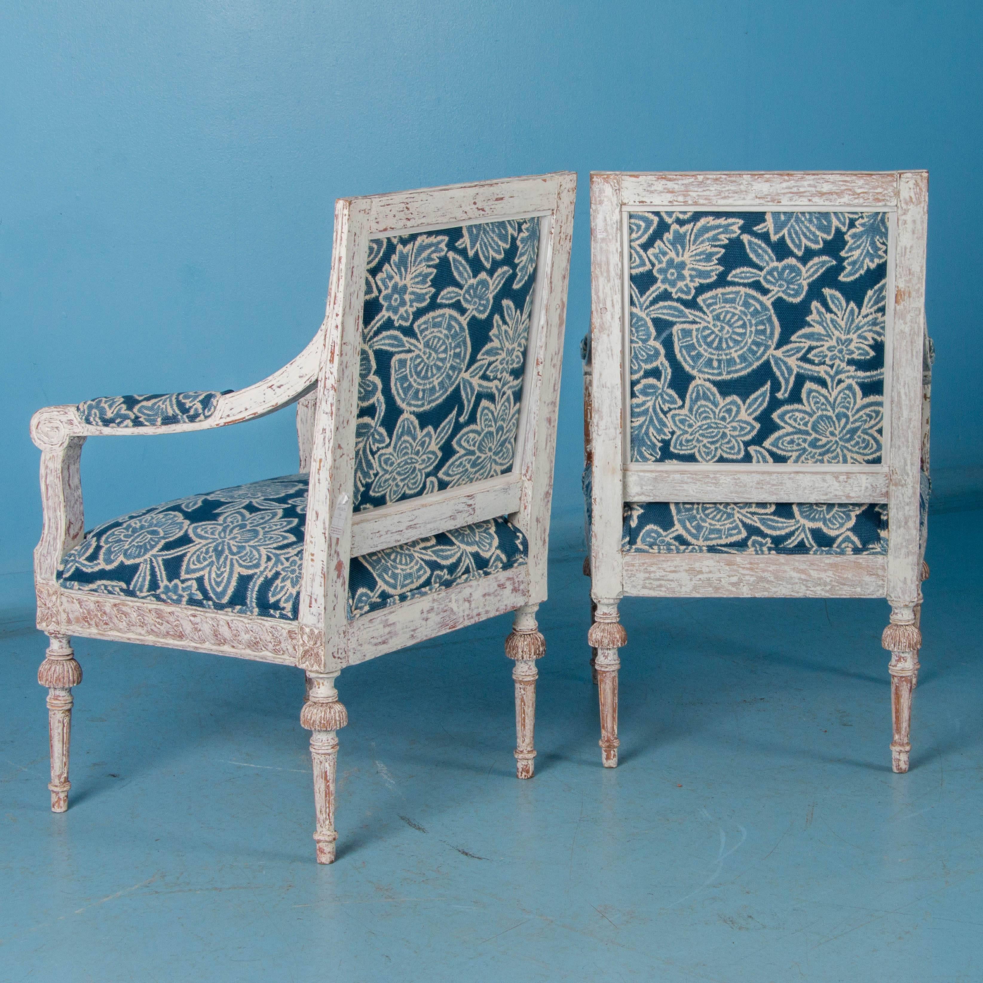 There is wonderful appeal to this this lovely pair of arm chairs which comes from a perfect blending of old and new. The enduring beauty of the original Gustavian style and craftsmanship is accentuated by the distressed white painted finish