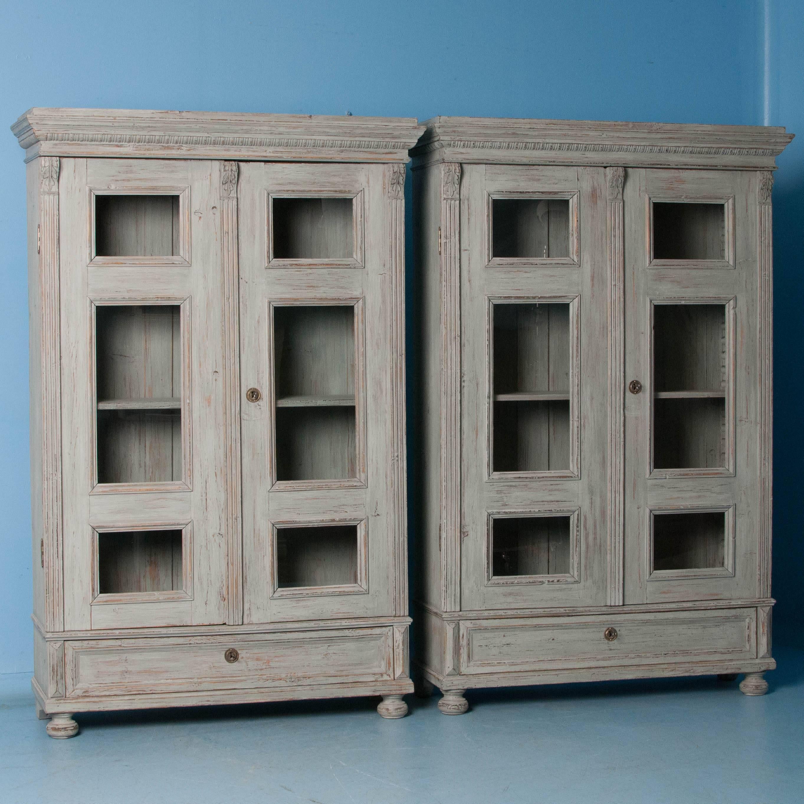 These exceptional bookcases are a tremendous find as it is difficult to find a matching pair. The lovely Gustavian gray chalk paint is perfectly distressed to fit with the age and character of the pair. One notices the symmetry and balance of the
