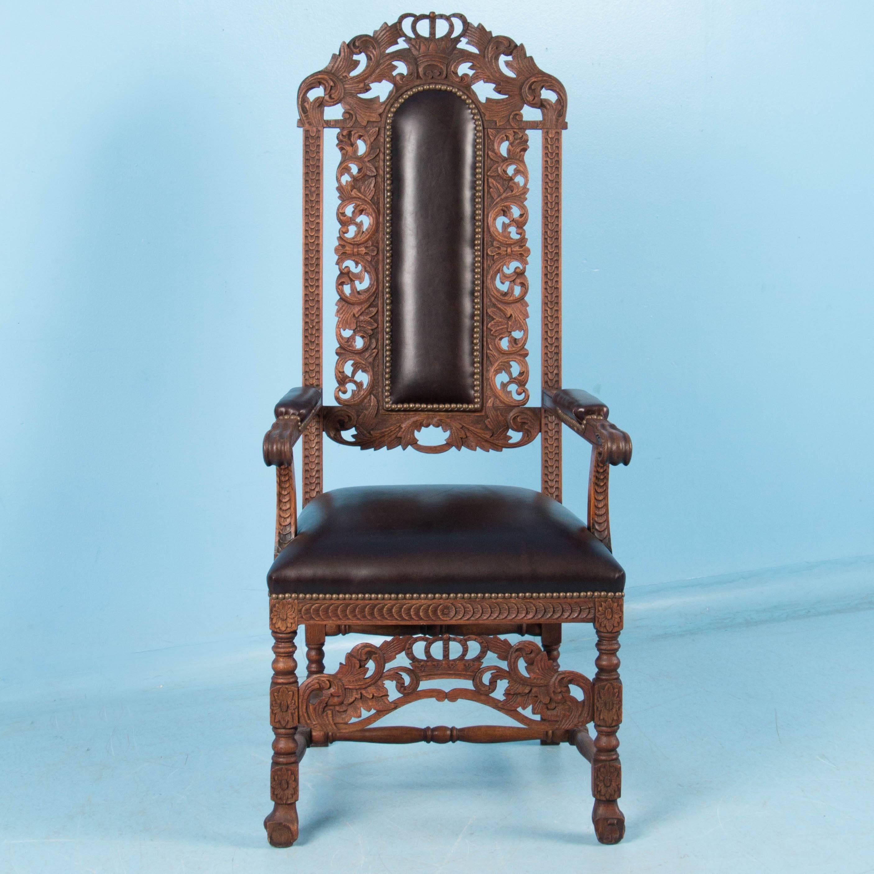 This handsome chair is ready to grace your home or office with both style and function. The hand-carved oak arms, feet and high back are traditional features of the Danish baroque period with a crown motif on the top center. The upholstered seat,