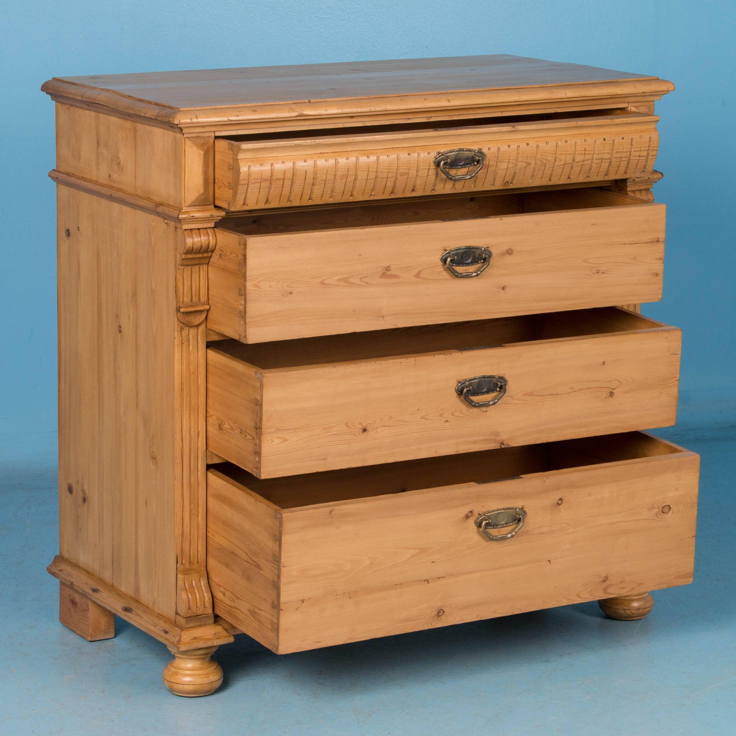 This lovely pine Chest of Drawers has been given a wax finish to bring out the warmth of the wood. The dentil molding along the top drawer and decorative fluted trim along the sides were often used as style elements in Danish chests from this
