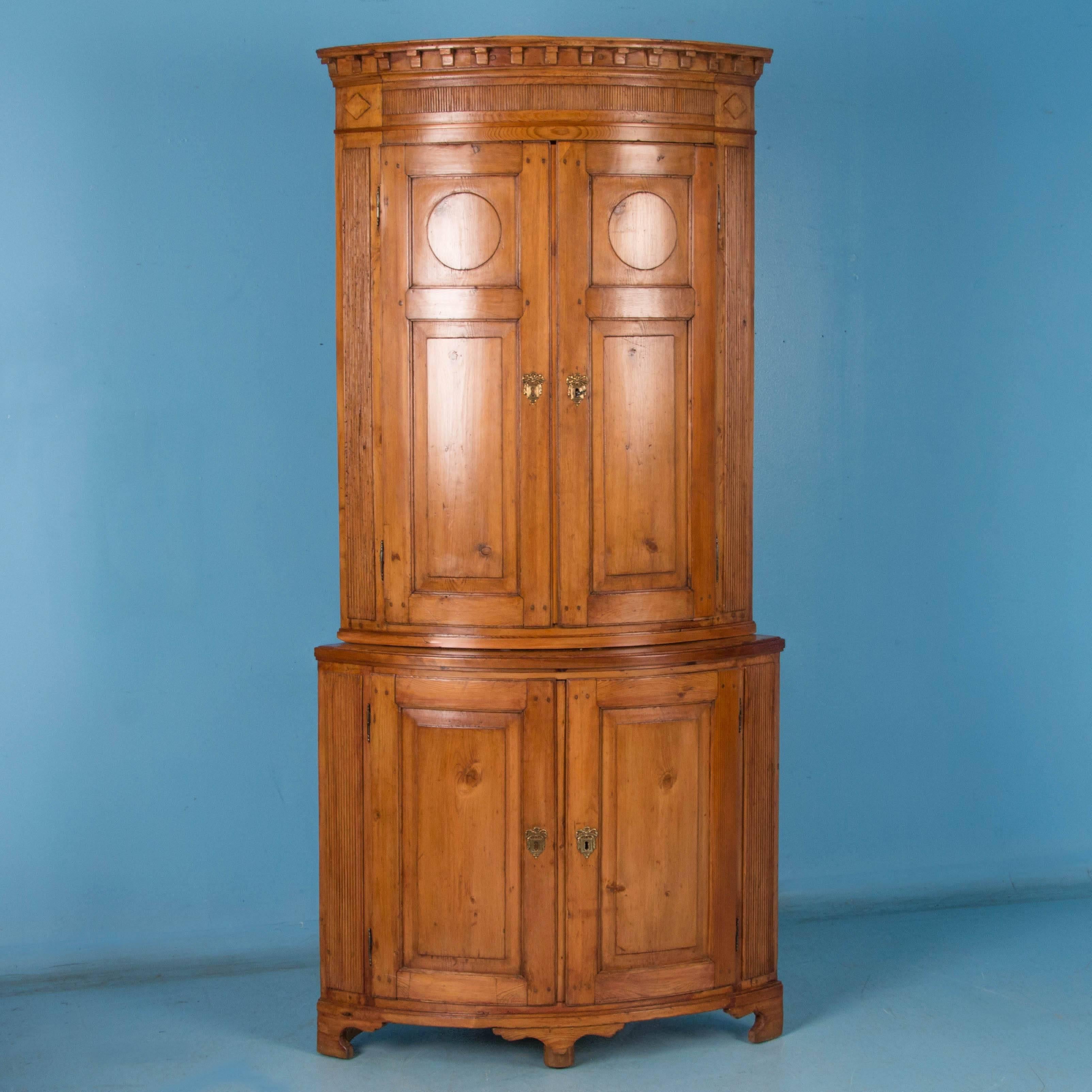 The lovely appeal of this graceful, tall corner cabinet is due to the elegant Louis XVI styling and rich warmth of the deep patina of the aged pine. Notice the fine details, such as the dentil molding of the crown, circular motif inside the top
