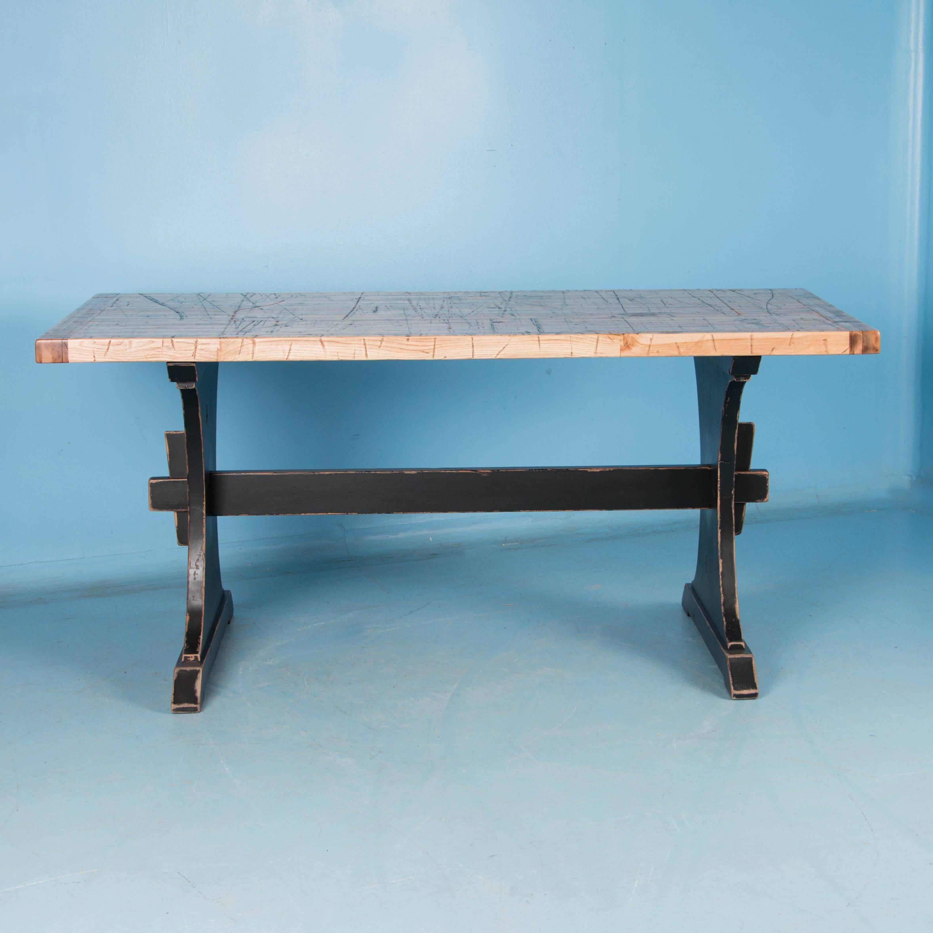 This unique counter height dining table was custom-made using reclaimed maple boxcar flooring. The distressed wood is a result of years of moving cargo through the train’s boxcars; it has been sanded and given a hard finish for daily use. Not only