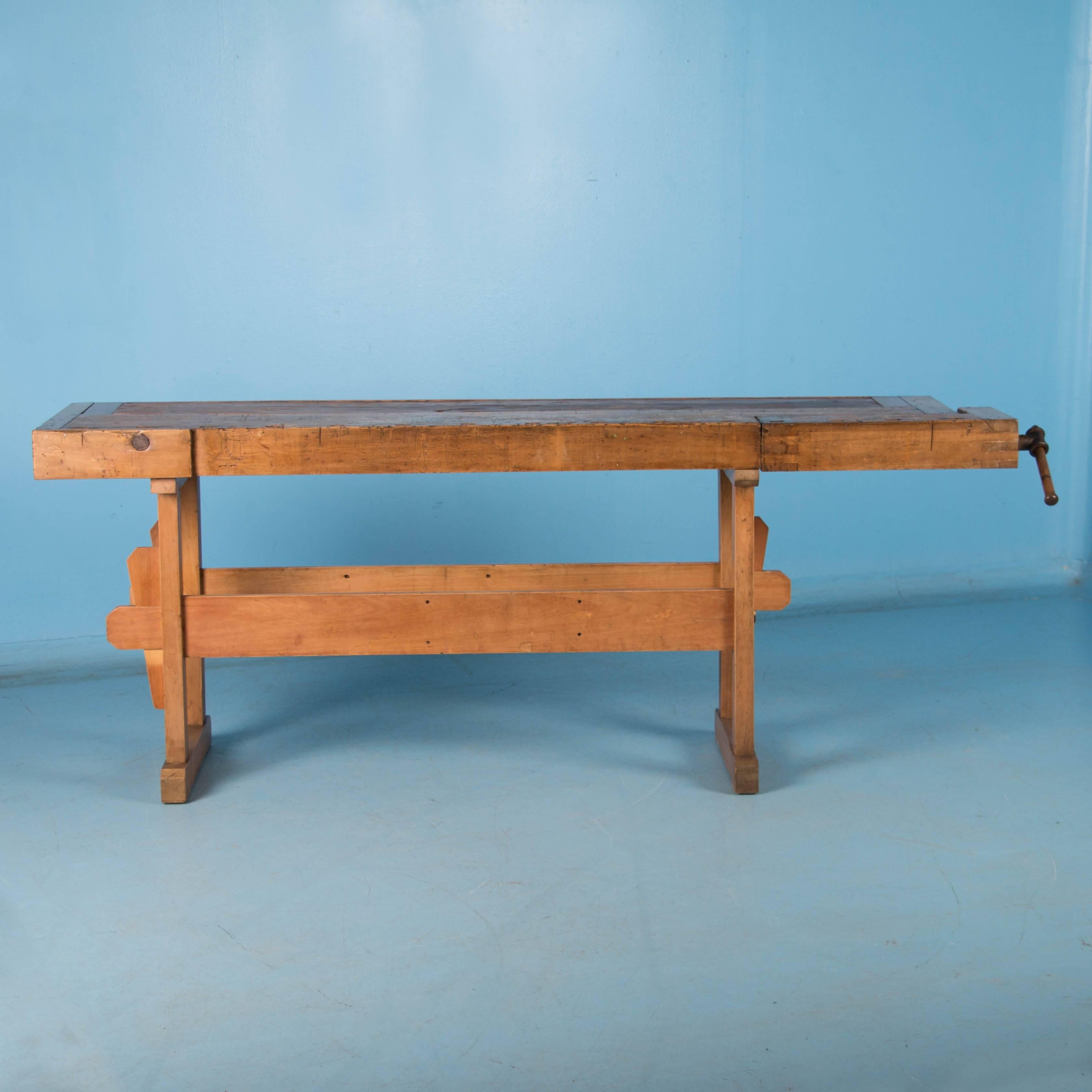 Rustic antique Danish carpenter's workbench, bearing an incredible patina after years of use. Workbenches such as this one are often used as console or sofa tables today. The usual recessed tray on top has been covered with antique pine creating a