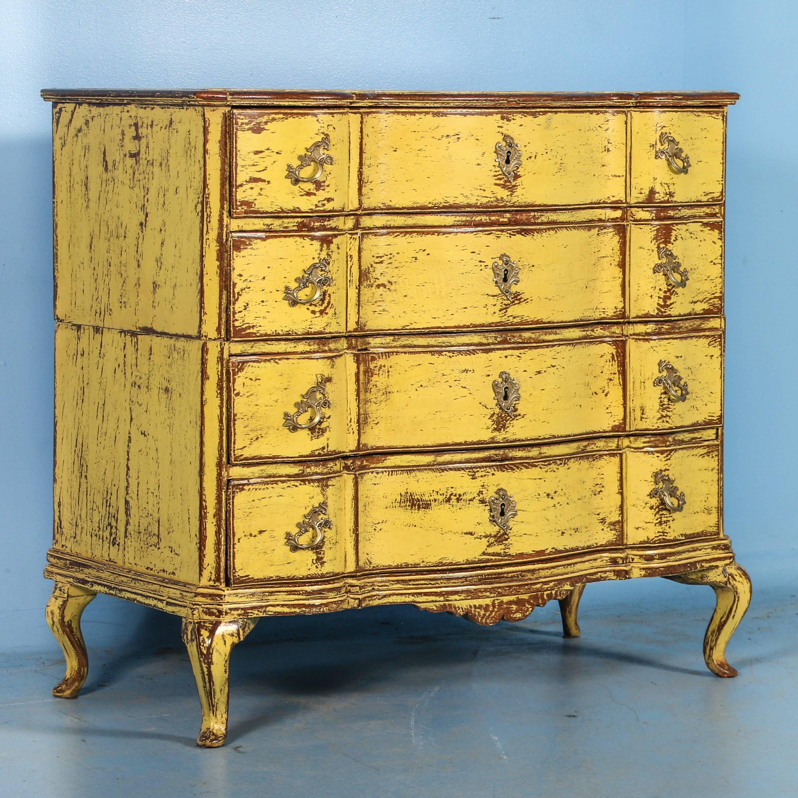 The classic serpentine curves of this rococo period chest draw ones eye to it, while the new yellow painted finish adds a stunning effect. The painted finish is exceptional, and perfectly distressed to compliment the age and character of the chest.