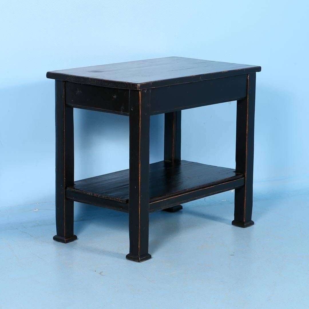 Antique country pine side table from Romania, circa 1880. Recently painted black, the table has been sanded in all the right places to show off the natural pine beneath giving it a country feel. The table has been professionally restored all joints