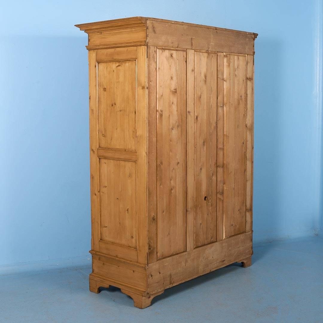 This antique pine double door armoire from Denmark, circa 1880 has been professionally restored inside and out - the cabinet is tight and finished with a satin hand rubbed wax. There are two shelves inside with the option of having more added. The
