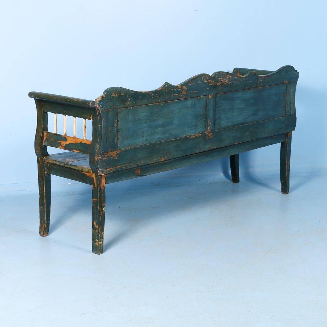 Wonderful antique pine bench from Hungary painted dark blue with white back panels, circa 1860. The distressed painted finish adds character and charm to this country bench. Where the paint is worn away, the natural pine shows through. This bench