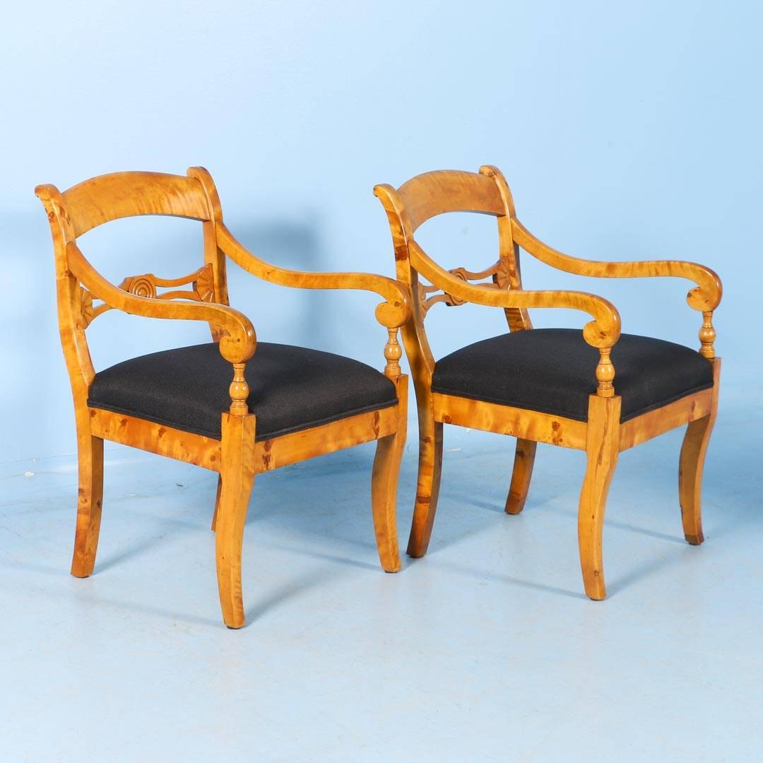 Stunning Pair of Karl Johan Swedish Arm Chairs circa 1840 made of flame birch with upholstered seats. Please examine the close up photos to appreciate the graceful curves and carving of the chairs, highlighted by the beauty of the remarkable birch
