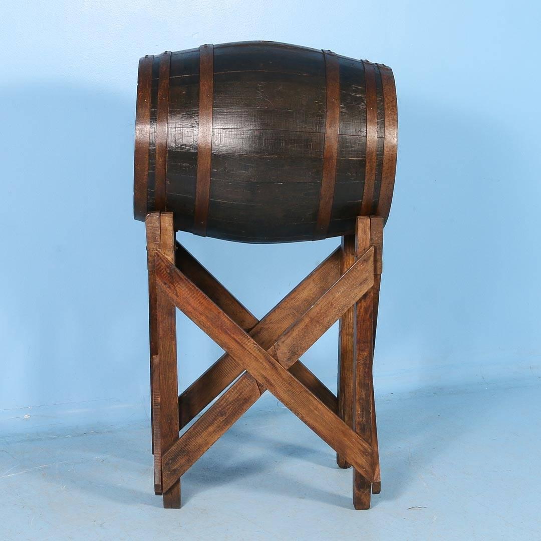 Antique oak wine barrel from France, circa 1900. The barrel is 24″ in diameter at it’s widest and rests on a separate hardwood base. The barrel and base have been finished with a satin wax. Great decorative accent, especially for a wine cellar or