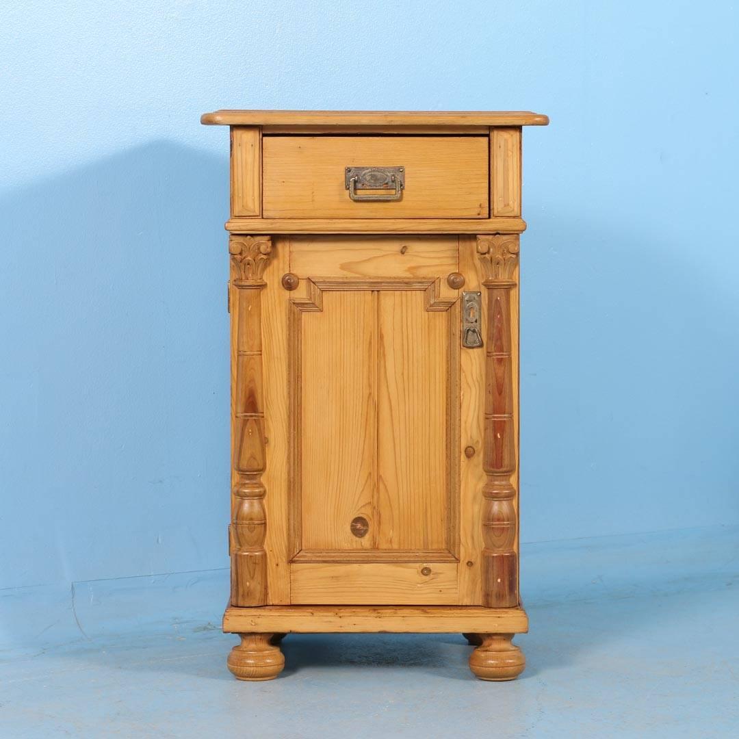 This 19th century pine nightstand from Hungary, circa 1880 has been professionally restored and finished with a satin wax. The single door is flanked by pilasters with carved Corinthian capitals adding great visual impact in a small space.
