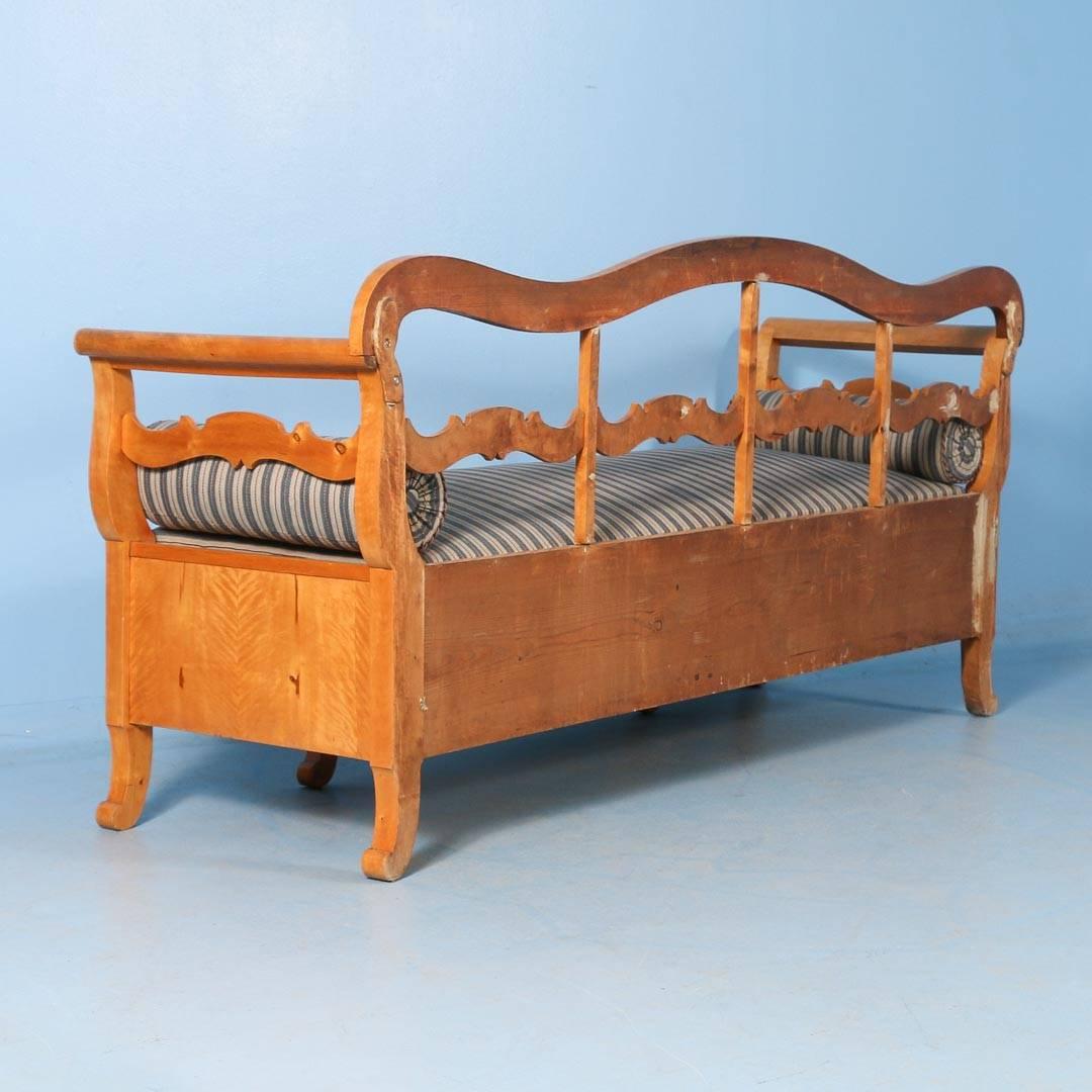 Antique Karl Johan Swedish bench with storage under the seat, is made of yellow birch. The seat cushion is removable and the upholstery can easily be changed out if desired. It has been professionally restored and is clean, strong and ready for