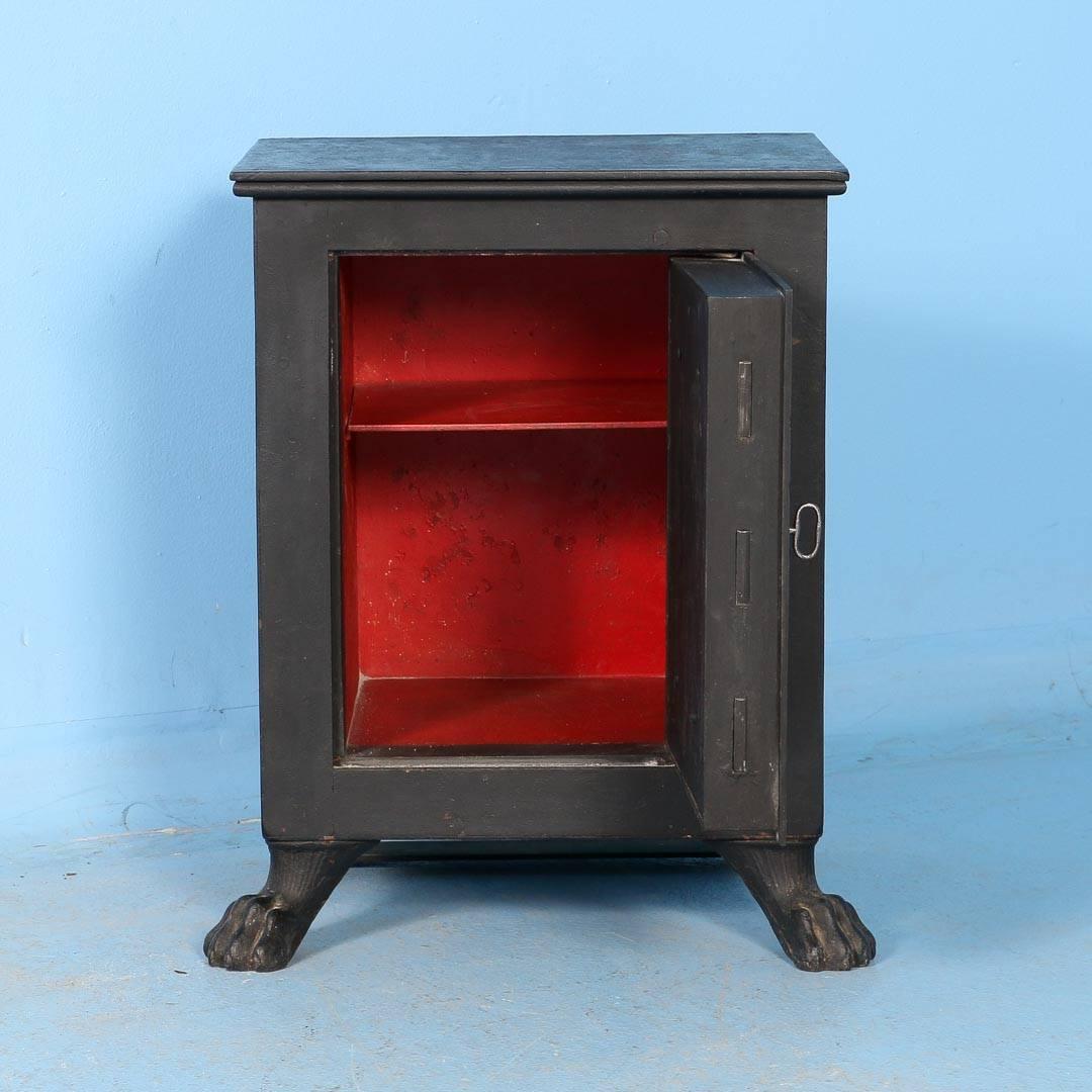 This antique iron safe from Denmark comes with the original key and is fully functional. The large center medallion hides the key hole and can be accessed by sliding one of the smaller rosettes. The two front cast iron pawed feet give the safe a