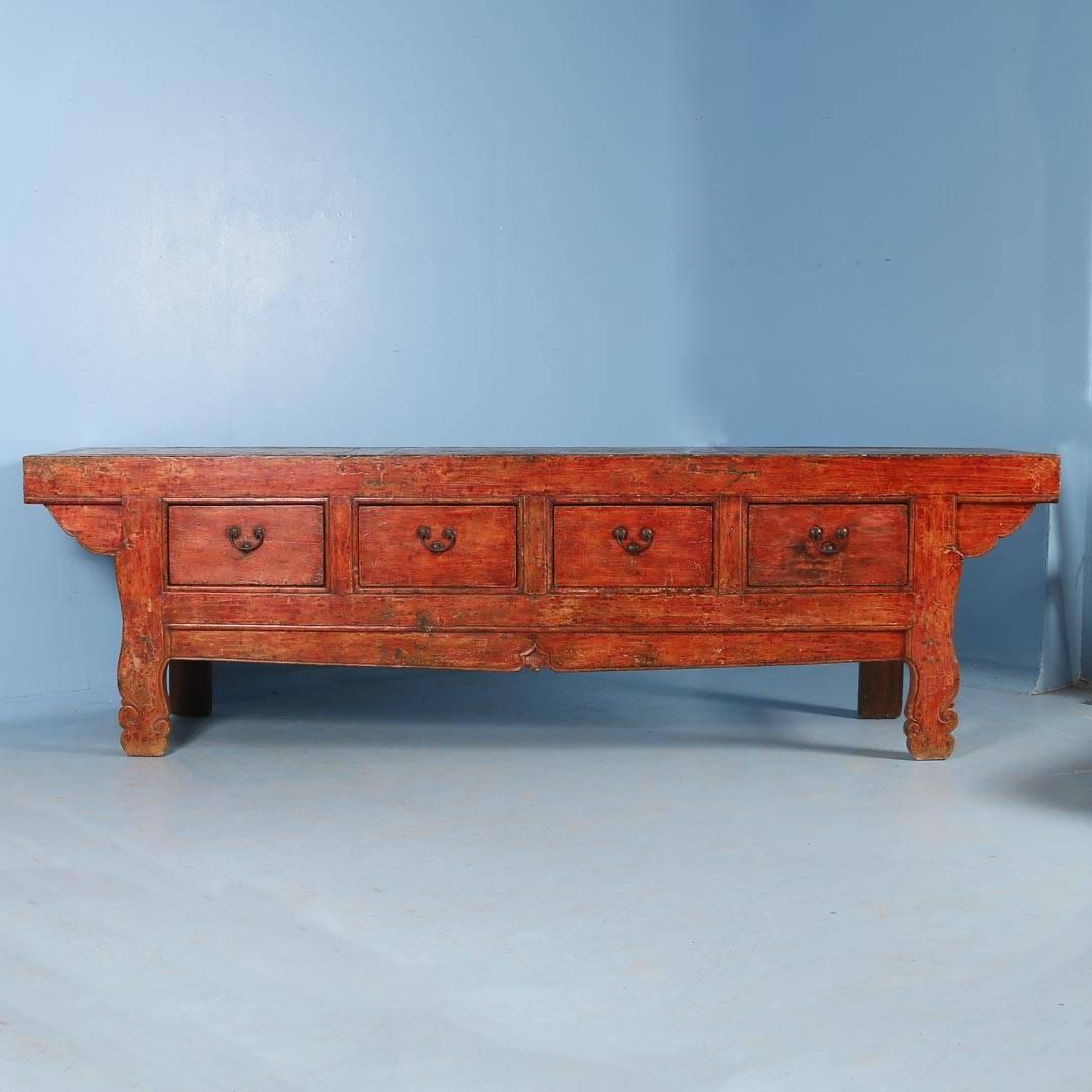 This magnificent sideboard makes an impressive visual statement due to its substantial size (over 10' long) and the truly remarkable color. It still maintains the original red paint, gently faded through the years revealing a slight orange undertone