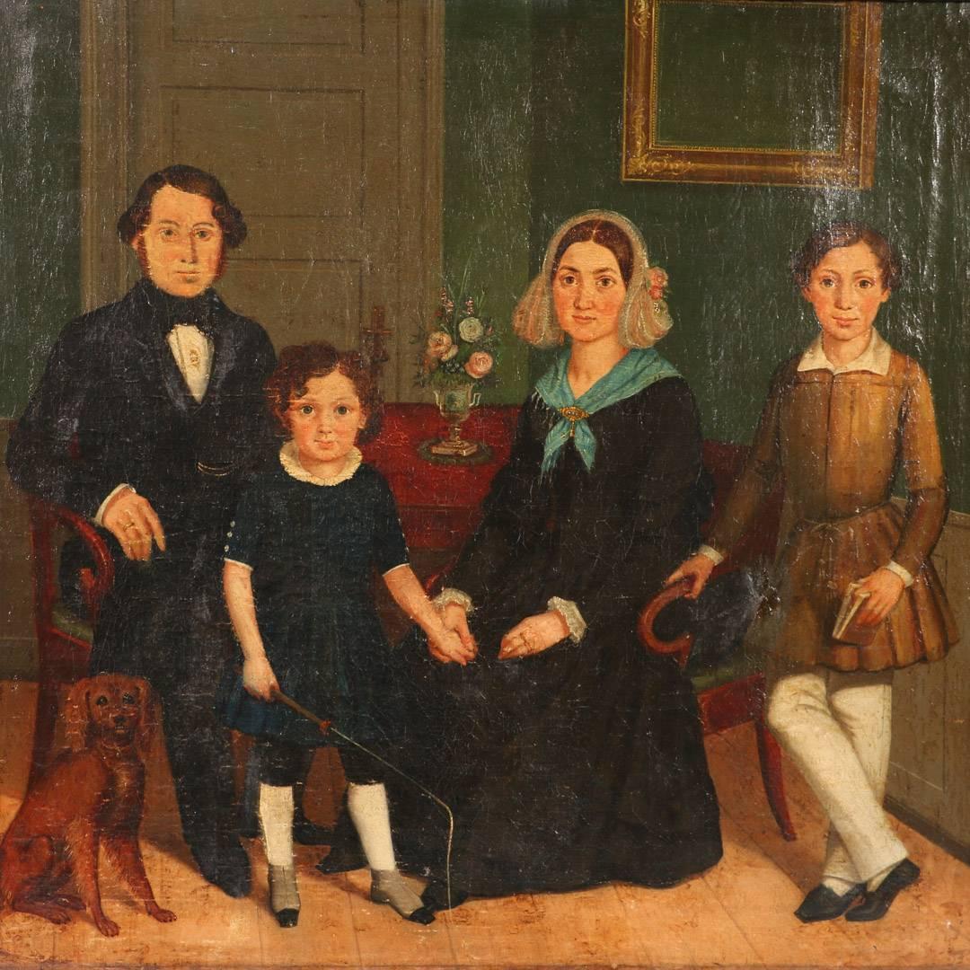 This antique Danish oil painting of a family portrait, circa 1820-1840, has wonderful detail and great period subject manner in an almost Primitive style. The artist shows the family with rosy cheeks and bright eyes in an interior setting, posing on