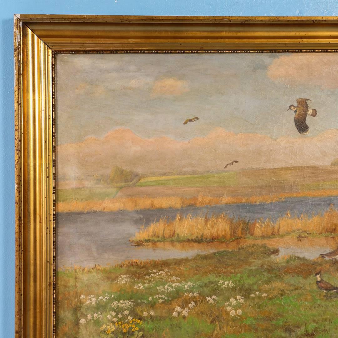 Vintage painting of shore birds in flight over a marsh, with a bucolic pasture and farm on the horizon. Signed in the lower left C. Hoyrup, the artist Carl Hoyrup (1893-1961) was known for his hunting and genre scenes. The painting is surrounded by
