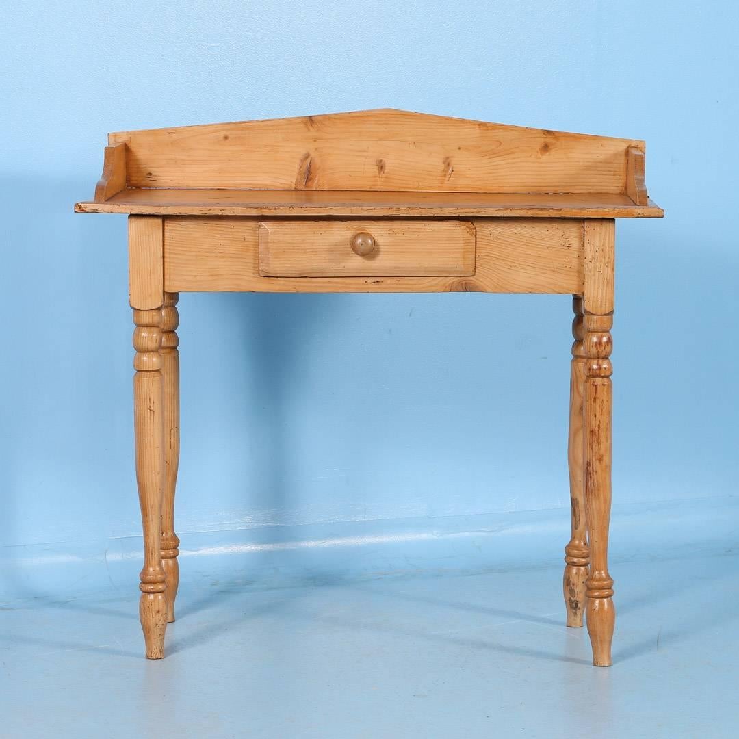 Charming antique pine side table from Denmark, circa 1880 with turned legs and a single drawer. This piece has been professionally restored and finished with a satin wax which enhances the country feel of this table. This would make a great entry