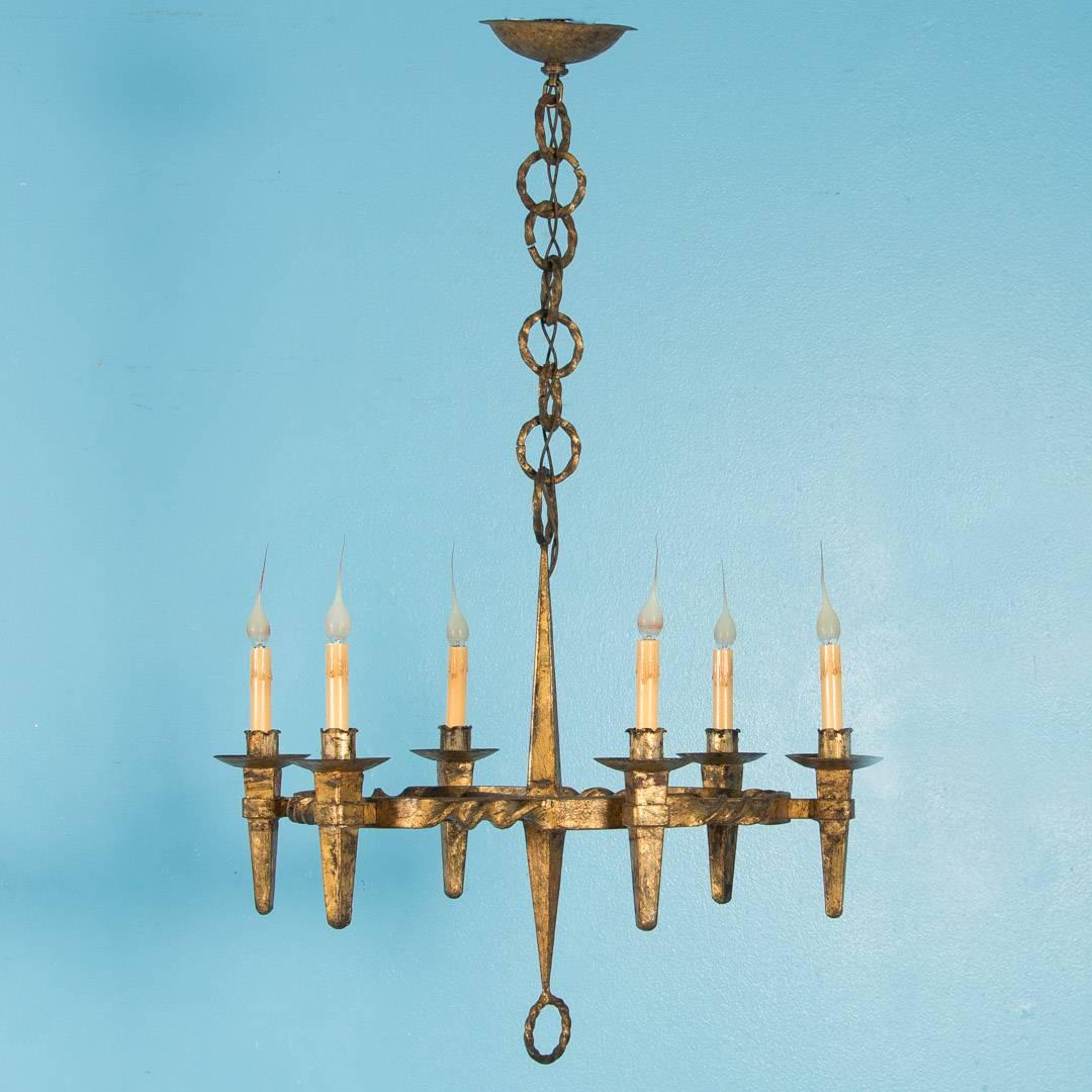 Antique gilded six light wrought iron chandelier from Denmark, circa 1900. The twisted rings top and bottom are repeated in the large chain that connects the canopy. The light has been rewired and is ready to be installed.

Scandinavian antiques