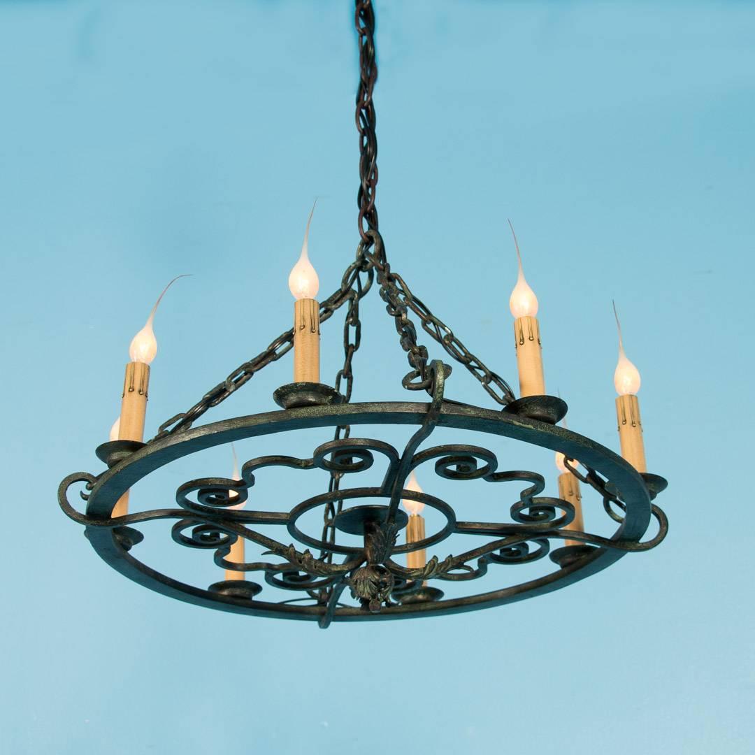 Antique Danish hand-wrought iron chandelier, circa 1920 with eight lights. A verdigris finish covers the entire piece including the chain and original canopy. This light has been re-wired and is in working condition.

Scandinavian antiques imports