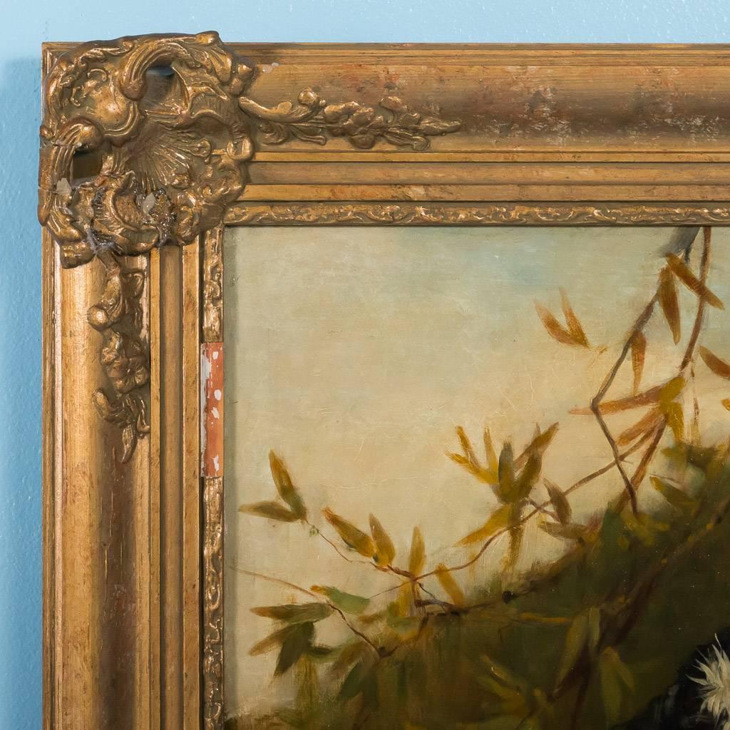 Antique English oil on canvas painting of a young woman holding a flower, signed in the lower right W. Oliver 1875. English artist William Oliver (1823-1901) was active from the mid to late 19th century. The painting is mounted in a period giltwood