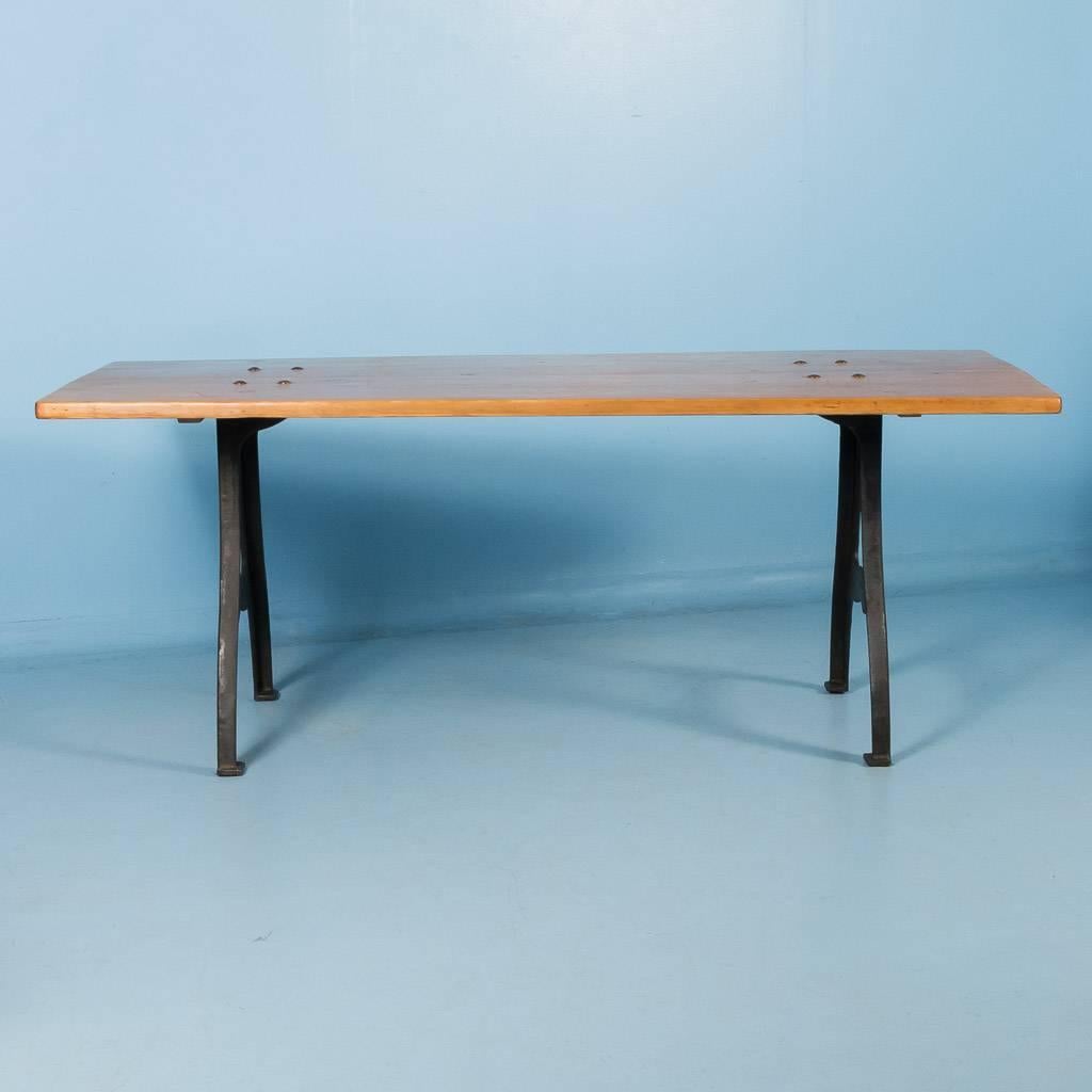 Antique pine tabletop from Denmark made up of four planks, circa 1880. The new cast iron legs give the table an Industrial look as well as stability. The tabletop has been restored and finished with a satin wax.

Scandinavian antiques imports