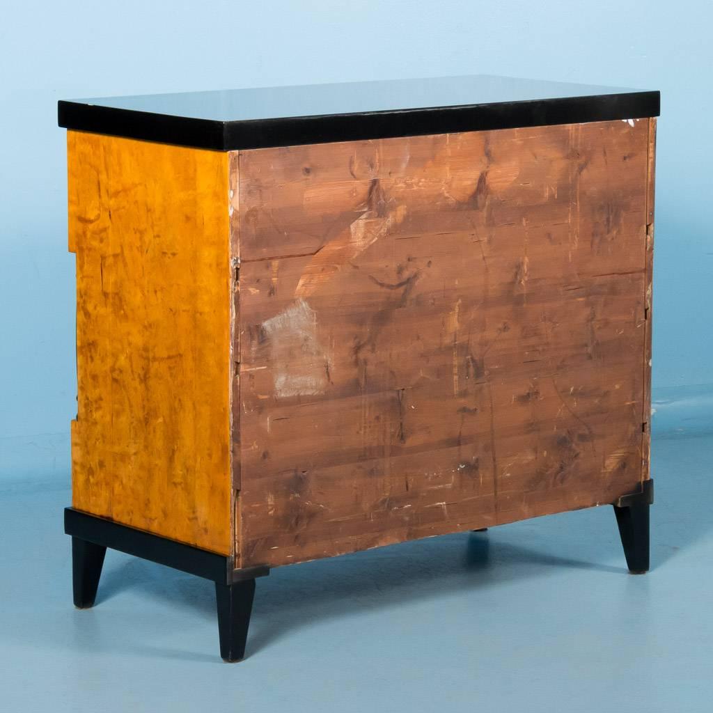 Antique Swedish Biedermeier chest of drawers with pull out desk, circa 1840. Each of the three-drawer fronts features extraordinary bookmatched birch burl with a thin band of dark inlay and bone key escutcheons. The top drawer when pulled out, can