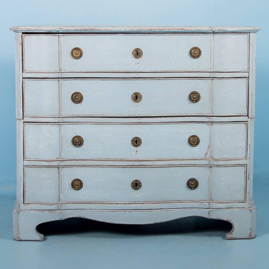 Mid-18th century Baroque oak chest of drawers from Denmark painted a light blue gray. The chest is made in two parts, each section with two bow front drawers. Where the exceptional blue gray paint has been scraped away, there are hints of the darker
