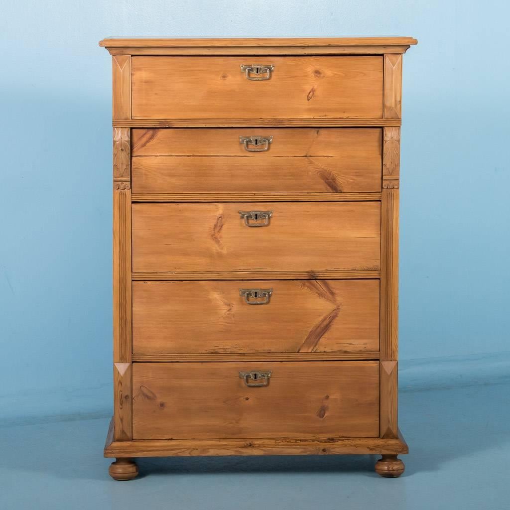 Antique 19th century Swedish pine highboy chest of drawers, circa 1890. The five drawers with matching brass pulls run smooth and graduate in size from larger at the bottom to smaller at the top. The pine has been given a wax finish, which accents