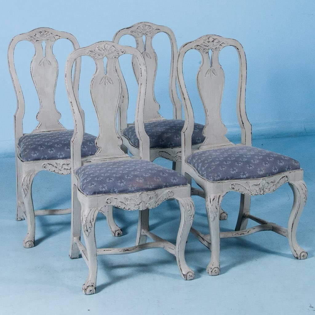 This lovely set of six dining chairs exude a graceful country charm. While likely from a Swedish farm house, these speak to a more upscale home with a touch of elegance due to the extra elements of carved details and the shapely curves of the backs