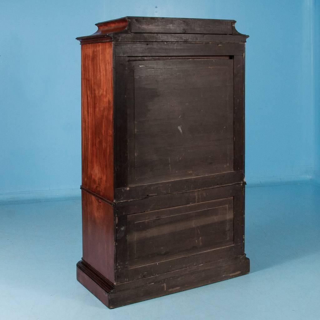 Antique 19th century mahogany highboy from Denmark with seven drawers. From the wonderful cove of the crown to the book-matched flame mahogany drawer fronts with their inlaid mother-of-pearl escutcheons, to the serpentine shape of the front, this