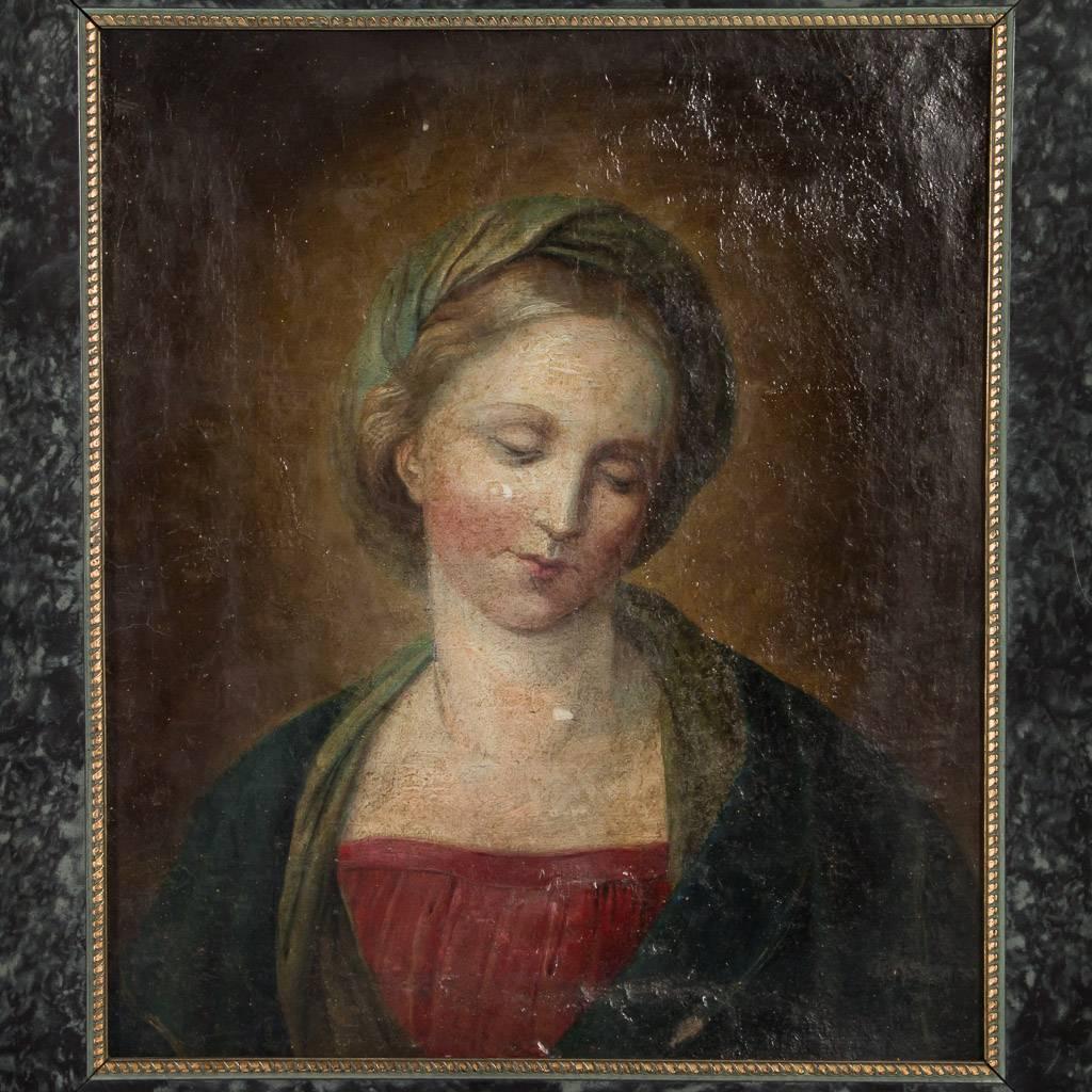 Early French 19th century original antique oil painting portrait of a woman, circa 1800. This well painted portrait of a robed young woman with her head tilted and looking serenely downward, is unsigned and mounted in a parcel-gilt and black wood