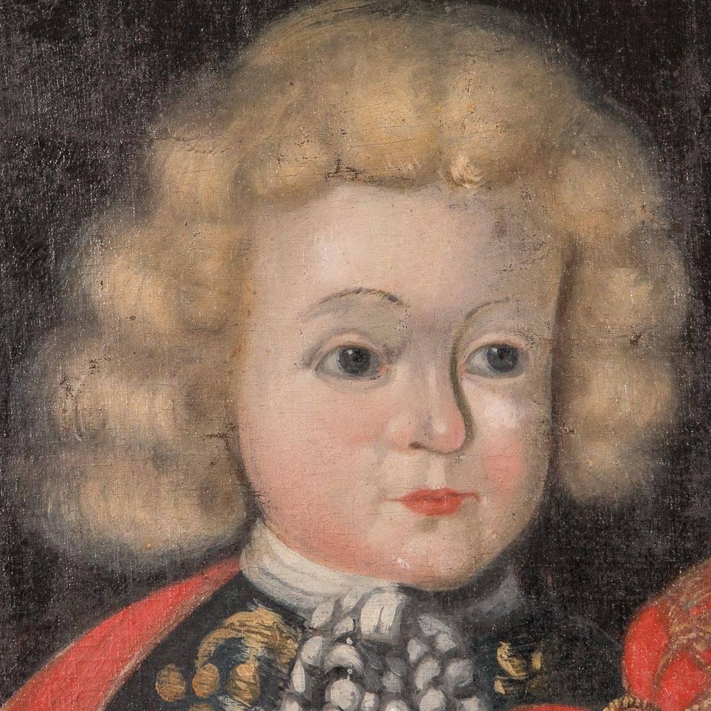 Original oil on canvas portrait painting of a child, likely royalty, dressed in a red cape, circa 1760-1800. The painting is unsigned and mounted in a painted wood frame. Please take a moment to enlarge the photos and examine the details up close.