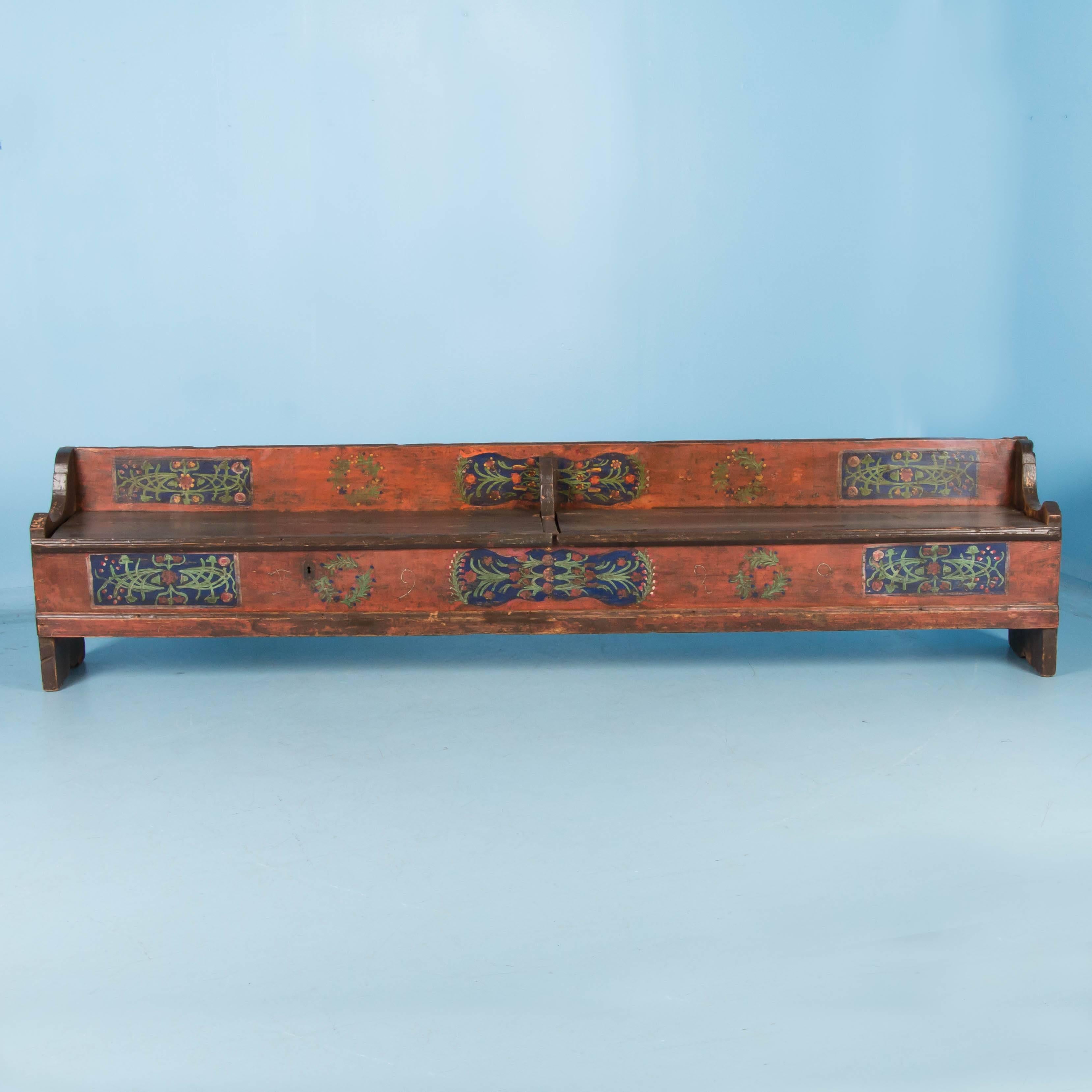 This long pine bench still maintains the original paint from 1929, when it was dated. The traditional Folk Art of the late 1800s into 1900s included floral motifs painted in panels, often using blue and red backgrounds such as this one. It has a low