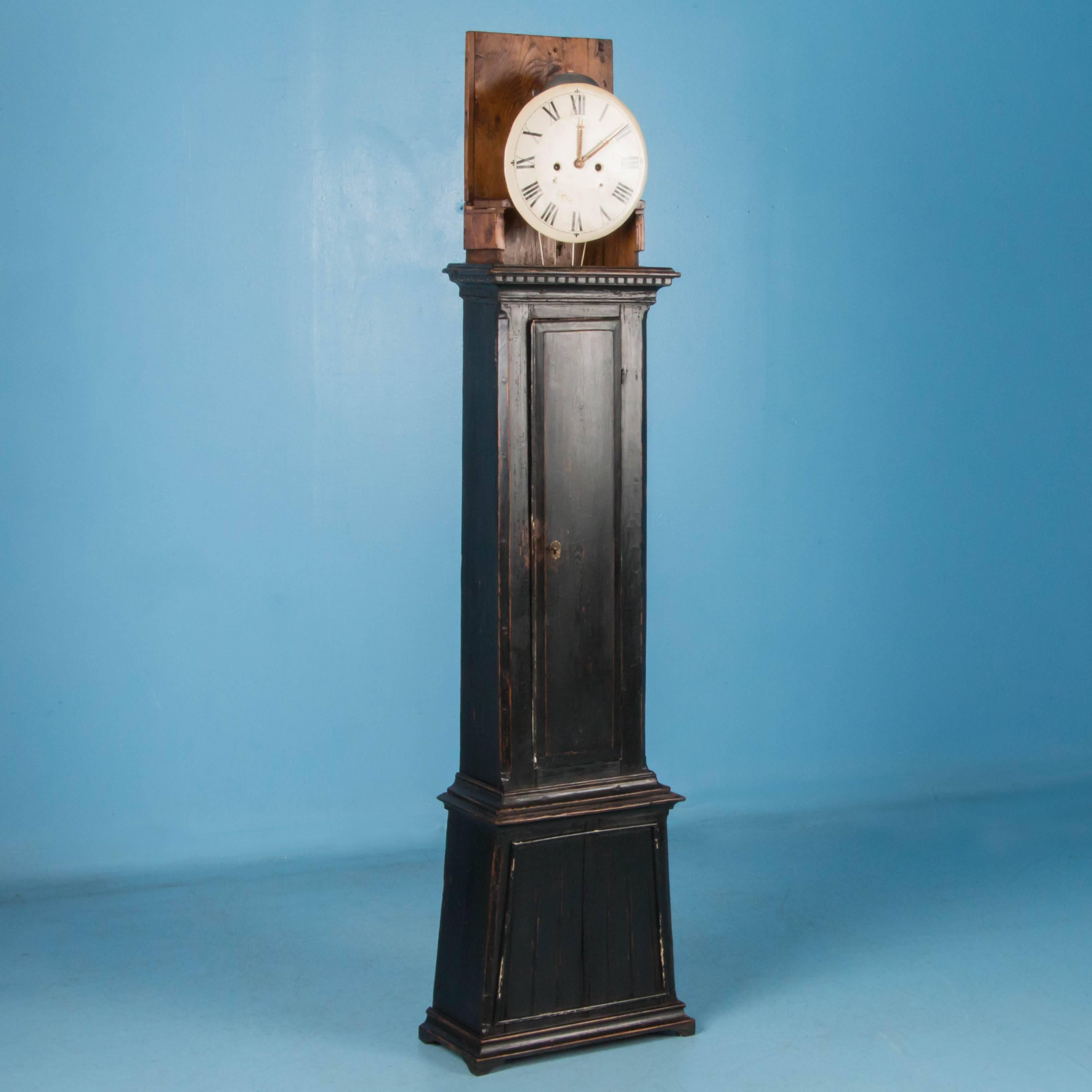 Antique grandfather clock from Denmark, circa 1840-1860 with a newer black painted finish. The paint has been lightly distressed exposing the natural pine and enhancing the carved details. Please take a moment to enlarge the photos and examine the
